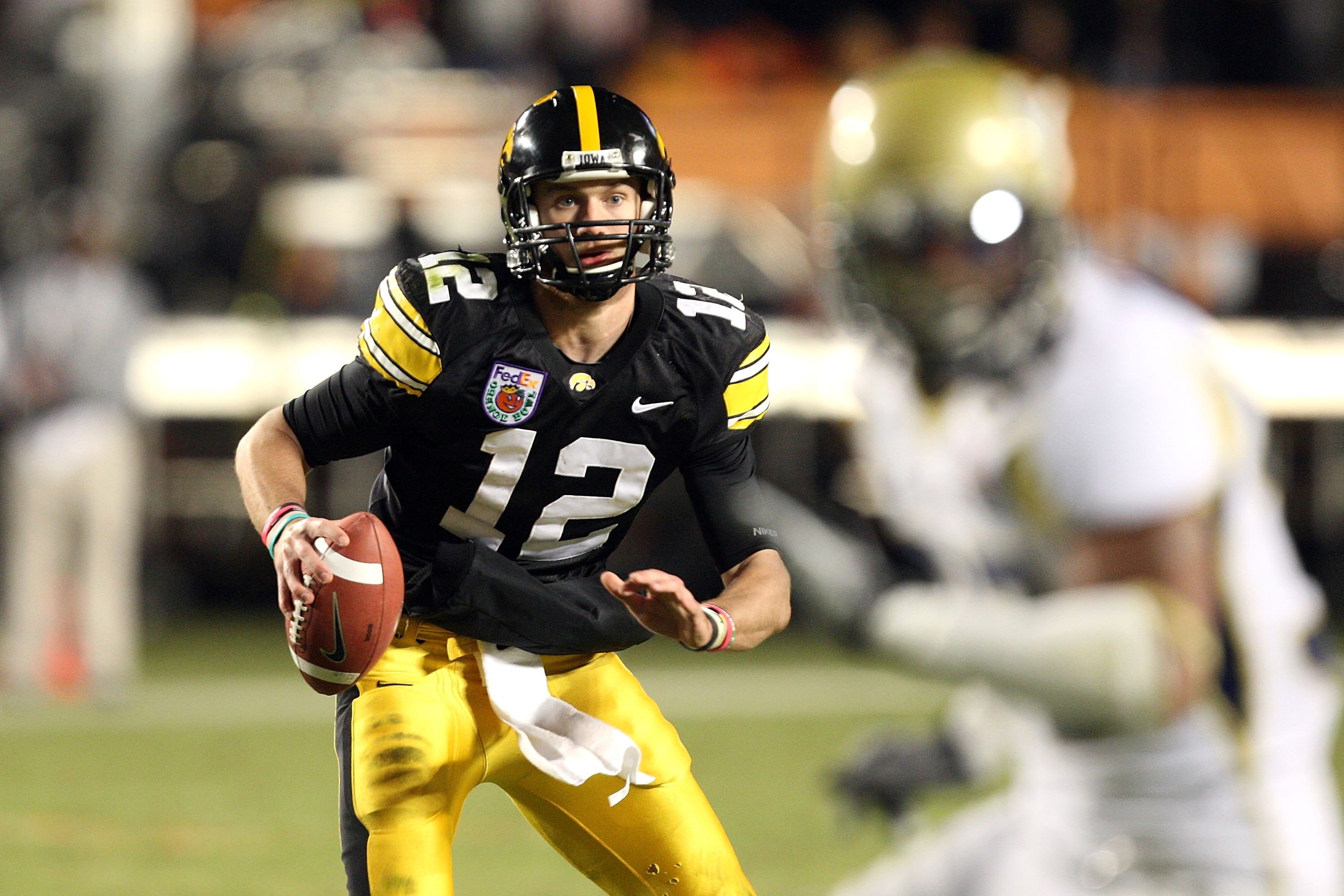 MIAMI GARDENS, FL - JANUARY 05:  Quarterback Richy Stanzi #12 of the Iowa Hawkeyes rolls out of the pocket against the Georgia Tech Yellow Jackets during the FedEx Orange Bowl at Land Shark Stadium on January 5, 2010 in Miami Gardens, Florida. Iowa won 24