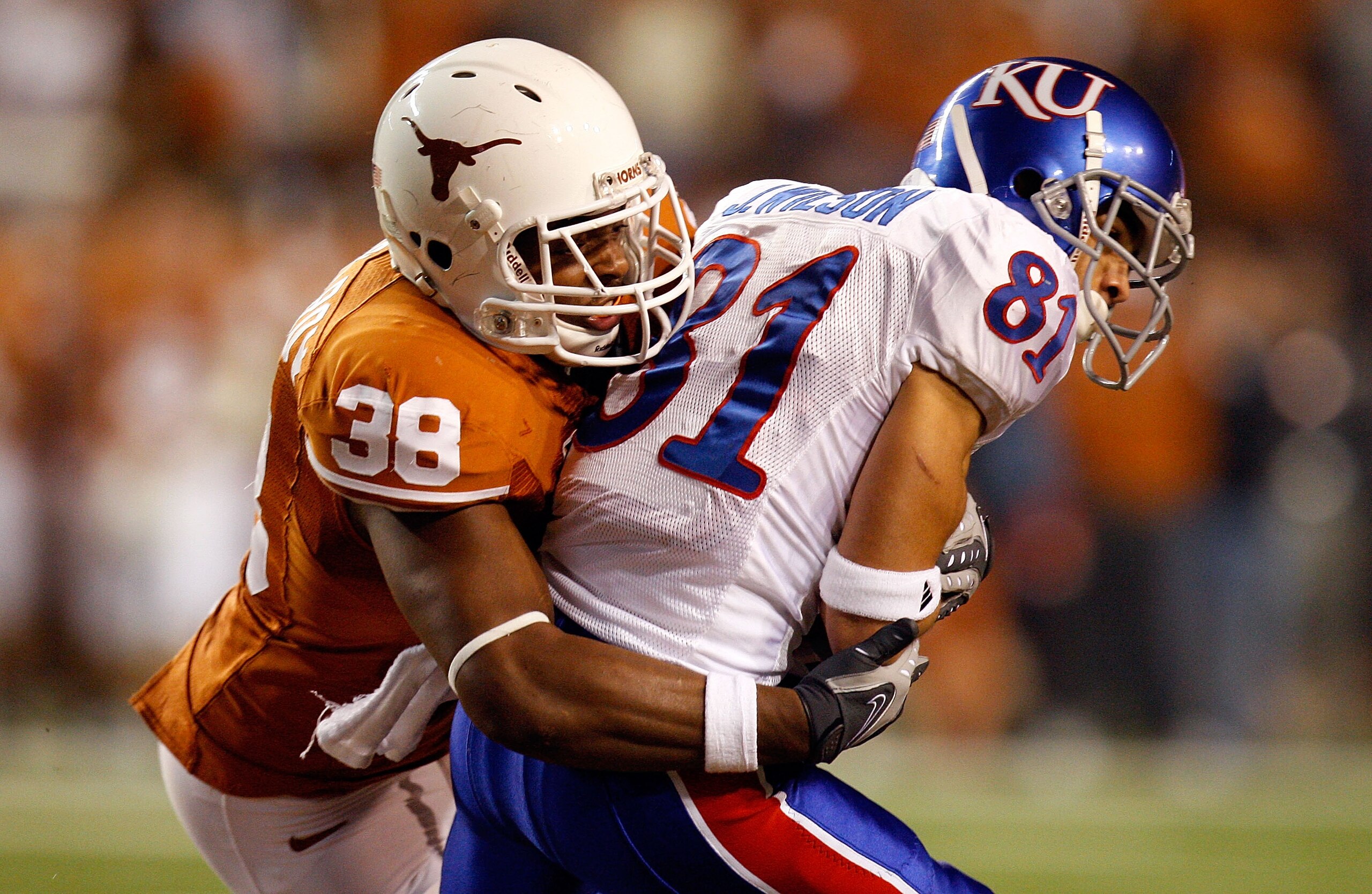 AUSTIN, TX - NOVEMBER 21:  Wide receiver Johnathan Wilson #81 of the Kansas Jayhawks is tackled by Roddrick Muckelroy #38 of the Texas Longhorns at Darrell K Royal-Texas Memorial Stadium on November 21, 2009 in Austin, Texas.  (Photo by Ronald Martinez/Ge