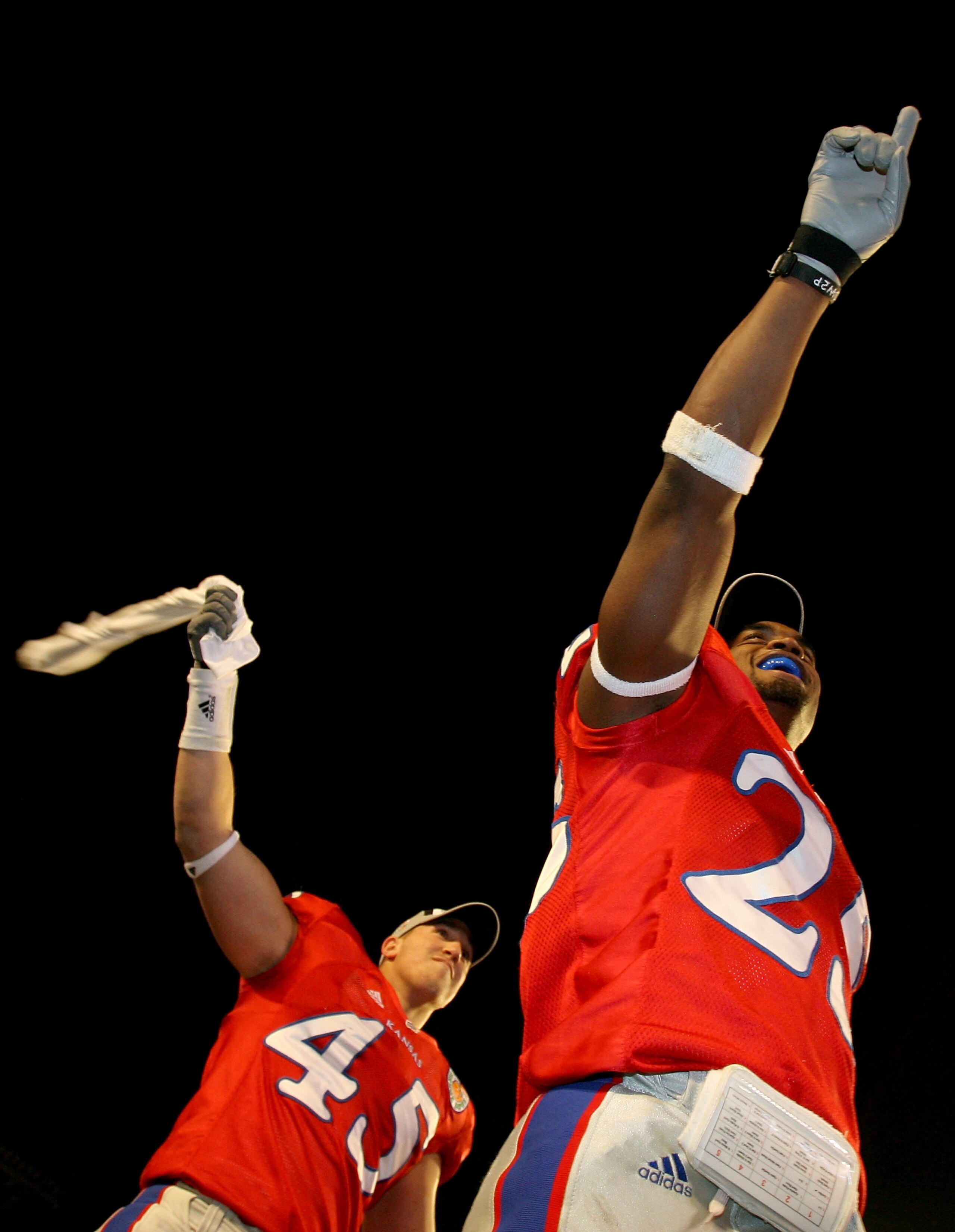 MIAMI - JANUARY 03:  Linebacker Justin Springer #45 and safety Darrell Stuckey #25 of the Kansas Jayhawks celebrate after their team's victory over the Virginia Tech Hokies during the FedEx Orange Bowl at Dolphin Stadium on January 3, 2008 in Miami, Flori