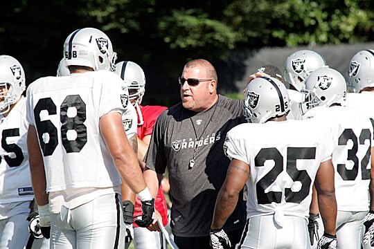 Jared Veldheer receives instructions from head coach Tom Cable.
