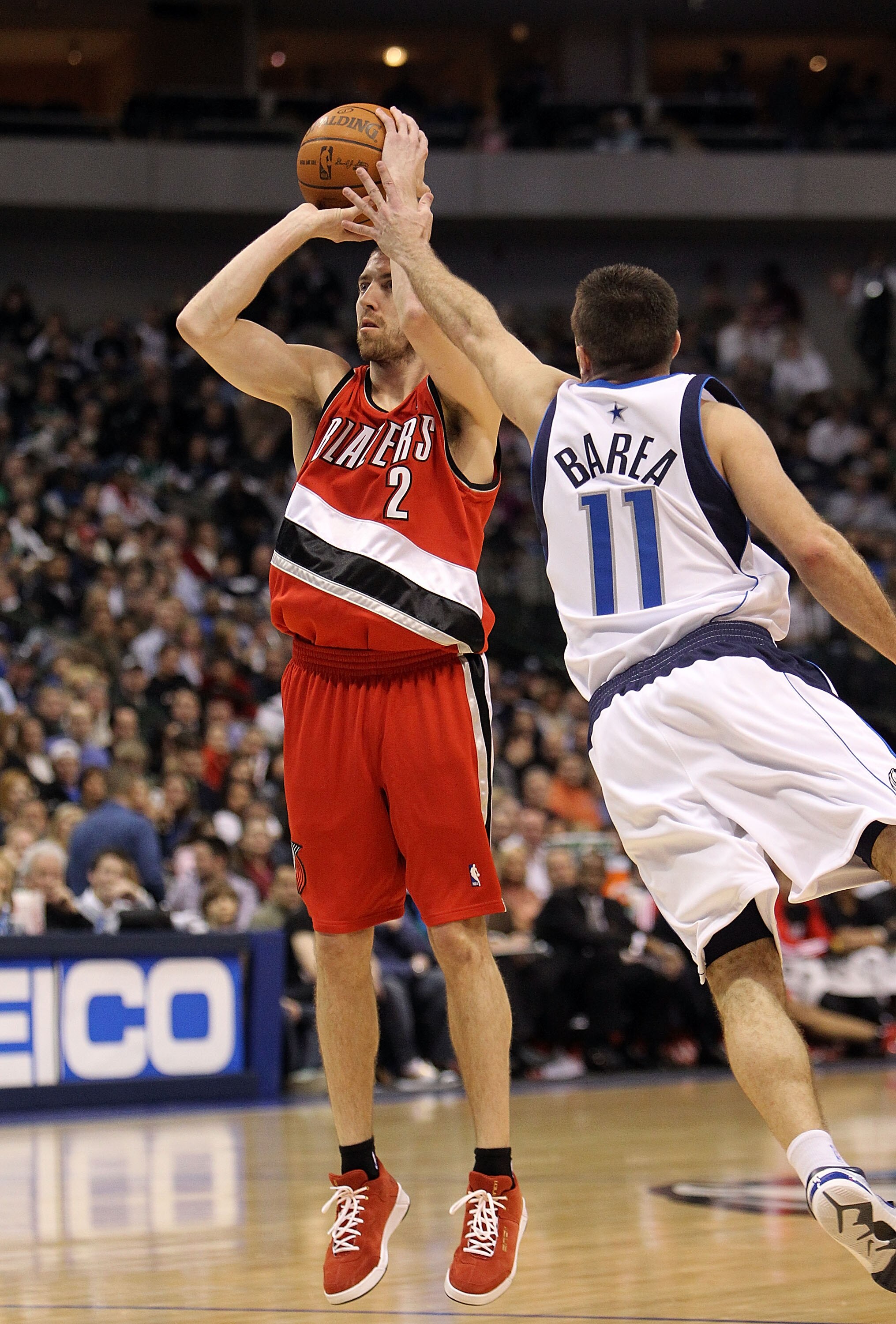 DALLAS - JANUARY 30:  Guard Steve Blake #2 of the Portland Trail Blazers takes a shot against Jose Juan Barea #11 of the Dallas Mavericks on January 30, 2010 at American Airlines Center in Dallas, Texas.  NOTE TO USER: User expressly acknowledges and agre