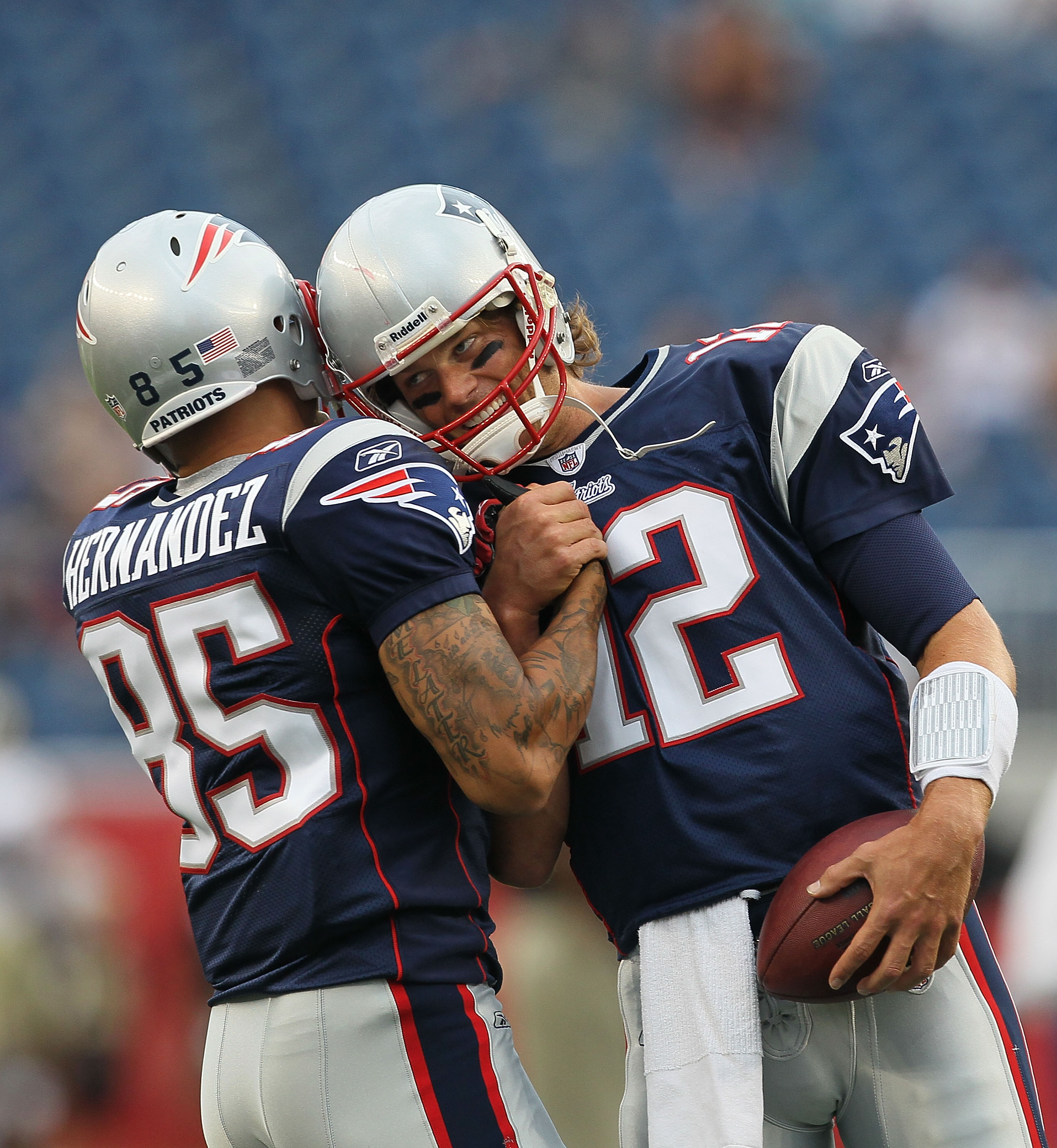 FOXBORO, MA - AUGUST 12: Aaron Hernandez  #85 and Tom Brady #12 of the New England Patriots greet each other before the the preseason game against the New Orleans Saints at Gillette Stadium on August 12, 2010 in Foxboro. Massachusetts. (Photo by Jim Rogas