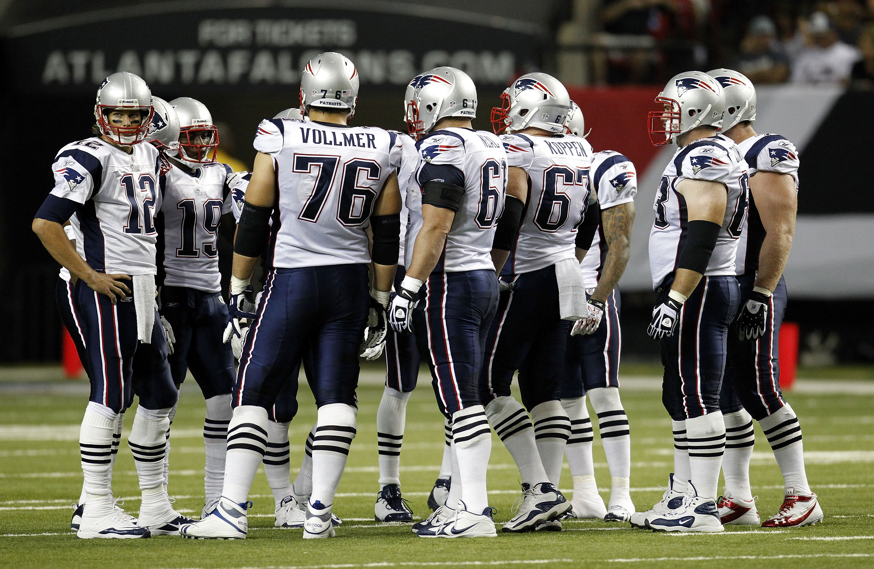 ATLANTA - AUGUST 19:  The New England Patriots offense, led by quarterback Tom Brady #12 (L), huddles before a play during the preseason game against the Atlanta Falcons at the Georgia Dome on August 19, 2010 in Atlanta, Georgia.  The Patriots beat the Fa