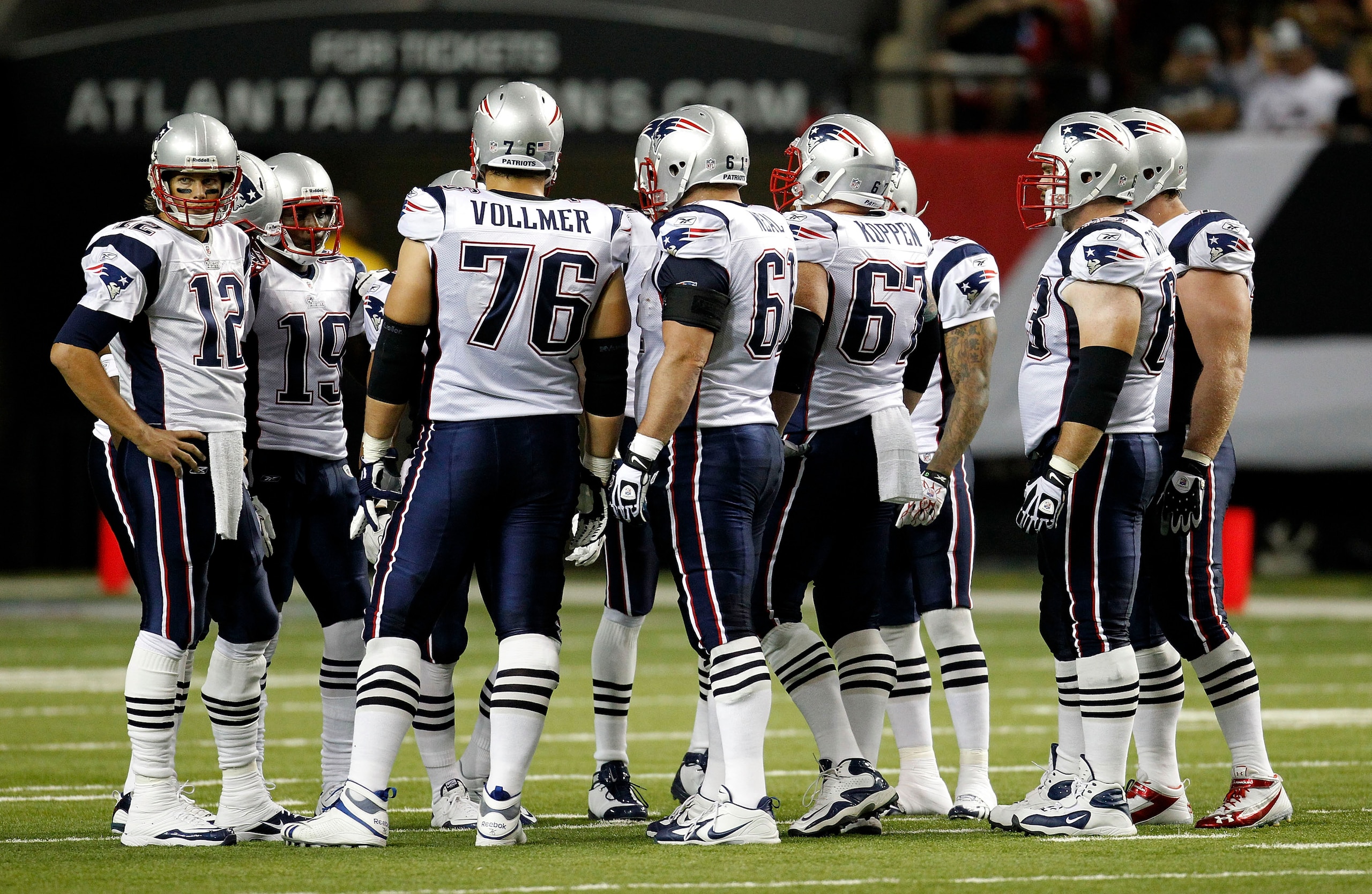 ATLANTA - AUGUST 19:  The New England Patriots offense, led by quarterback Tom Brady #12 (L), huddles before a play during the preseason game against the Atlanta Falcons at the Georgia Dome on August 19, 2010 in Atlanta, Georgia.  The Patriots beat the Fa