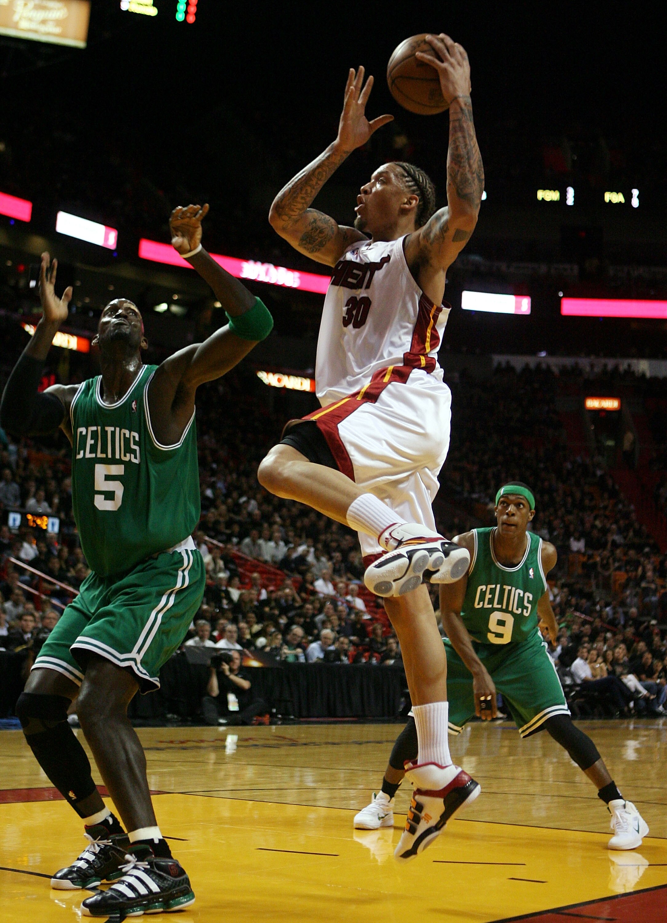 MIAMI - APRIL 23:  Forward Kevin Garnett #5 of the Boston Celtics defends against forward Michael Beasley #30 of the Miami Heat in Game Three of the Eastern Conference Quarterfinals during the 2010 NBA Playoffs at American Airlines Arena on April 23, 2010