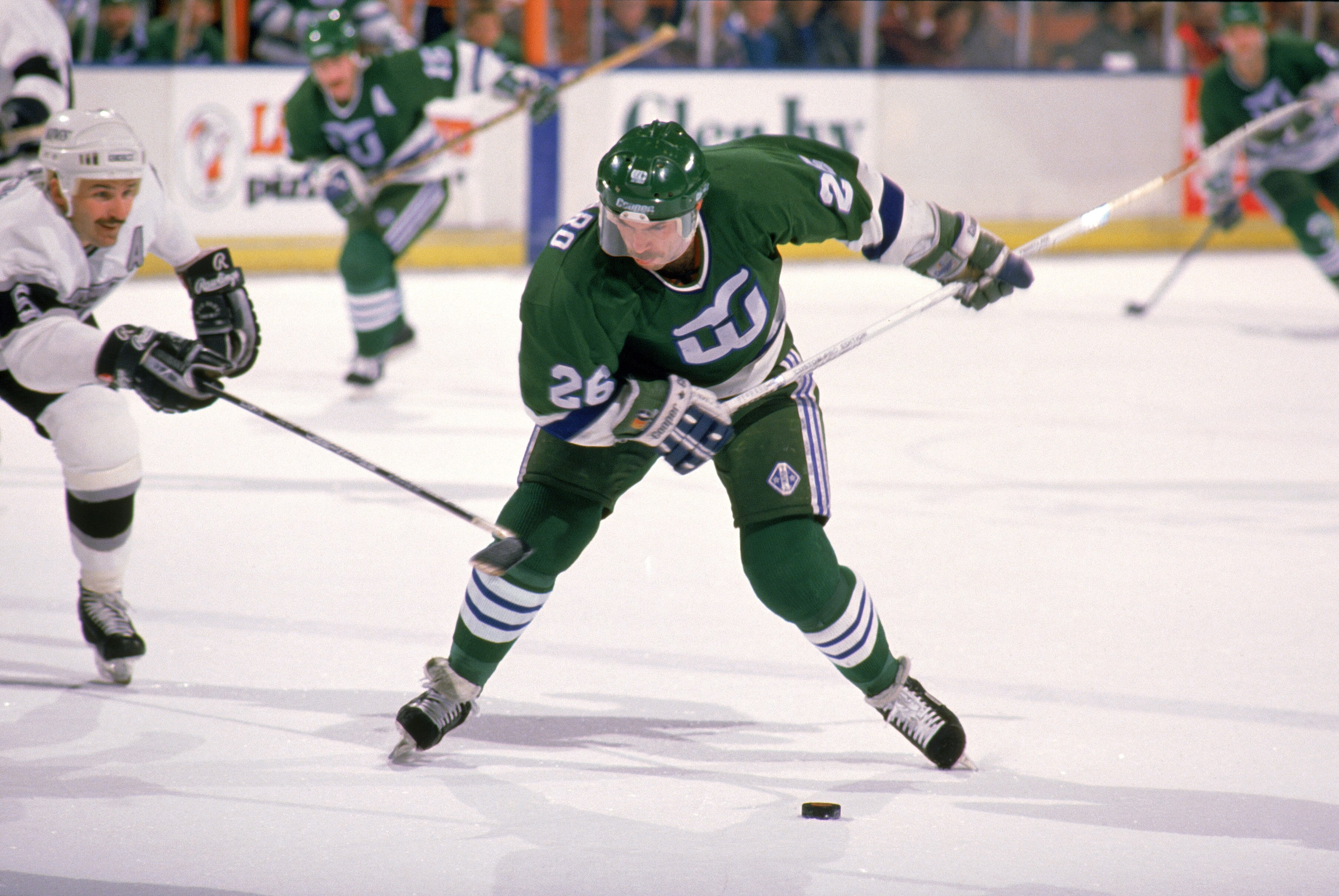 LOS ANGELES - 1989:  Ray Ferraro #20 of the Hartford Whalers takes a shot during a game against the Los Angeles Kings in the 1988-1989 season at the Great Western Forum in Los Angeles, California.  (Photo by Tim DeFrisco/Getty Images)