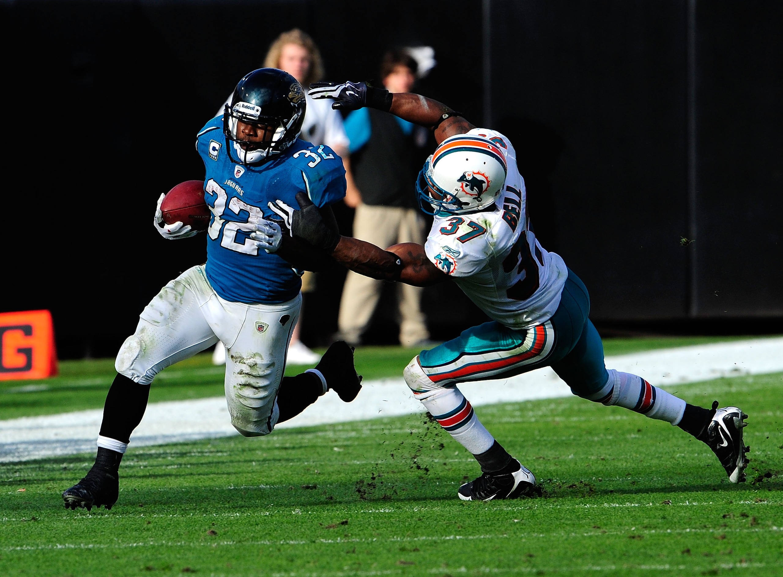 JACKSONVILLE, FL - DECEMBER 13: Yeremiah Bell #37 of the Miami Dolphins attempts to tackle Maurice Jones-Drew #32 of the Jacksonville Jaguars during the game at Jacksonville Municipal Stadium on December 13, 2009 in Jacksonville, Florida. (Photo by Sam JACKSONVILLE, FL - DECEMBER 13: Yeremiah Bell #37 of the Miami Dolphins attempts to tackle Maurice Jones-Drew #32 of the Jacksonville Jaguars during the game at Jacksonville Municipal Stadium on December 13, 2009 in Jacksonville, Florida. (Photo by Sam
