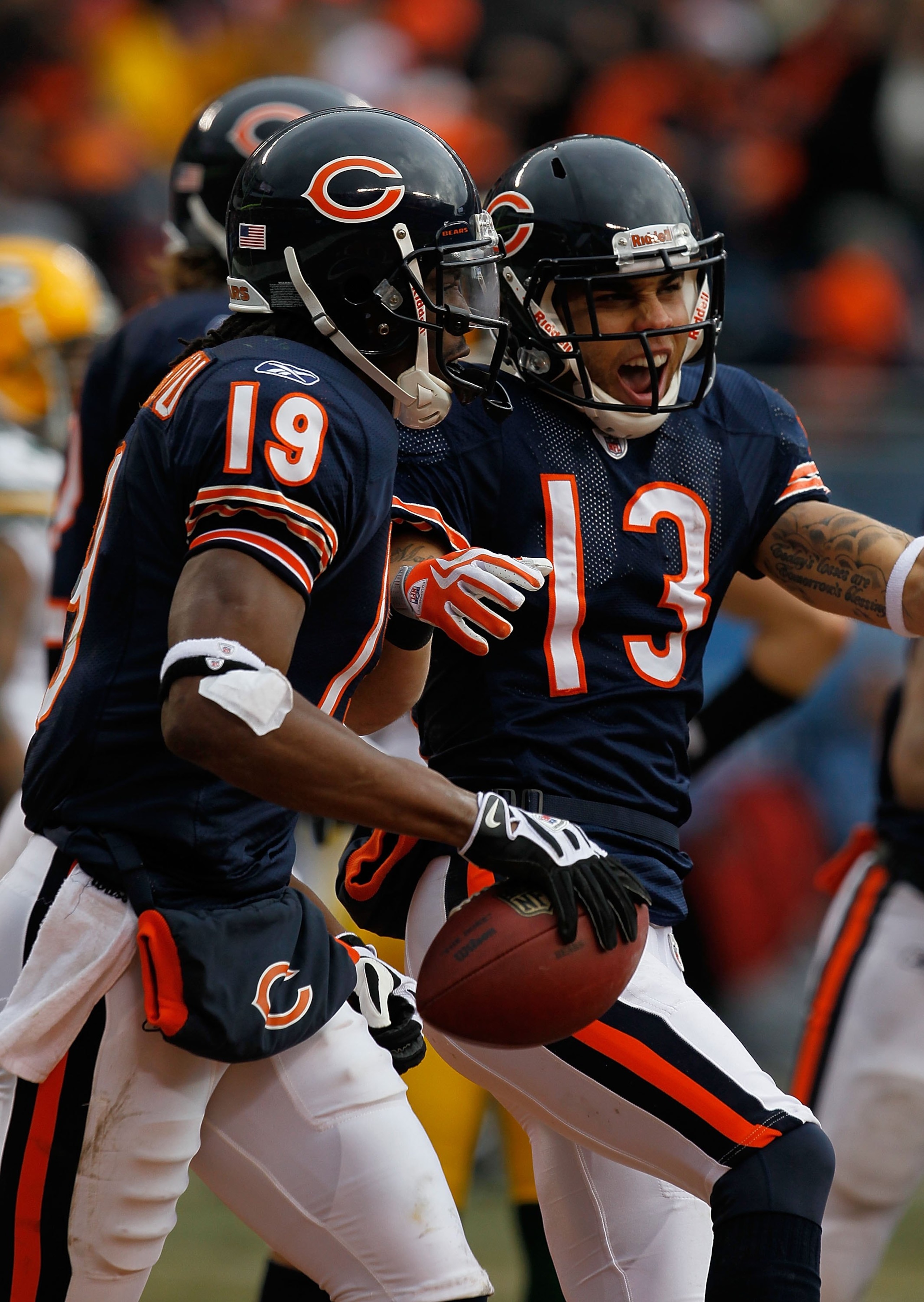 CHICAGO - DECEMBER 13: Devin Aromashodu #19 and Johnnny Knox #13 of the Chicago Bears celebrate after a touchdown against the Green Bay Packers at Soldier Field on December 13, 2009 in Chicago, Illinois. The Packers defeated the Bears 21-14. (Photo by Jon
