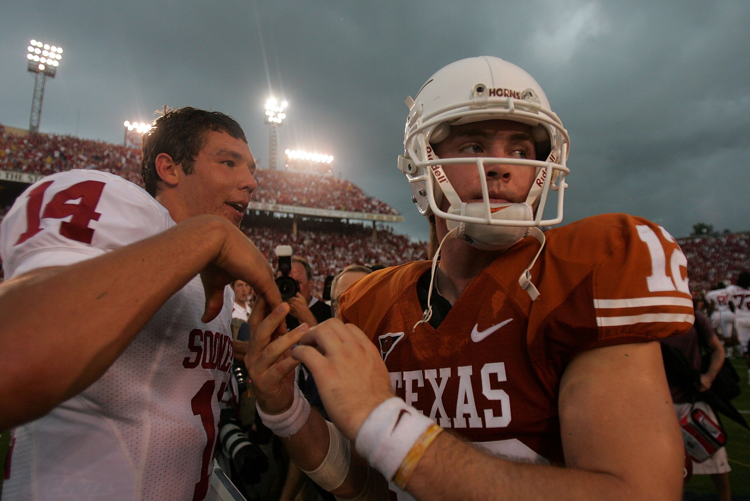 DALLAS - OCTOBER 6:  Quarterback Sam Bradford #14 of the Oklahoma Sooners and Colt McCoy of the Texas Longhorns after the Sooners defeated the Longhorns 28-21 at the Cotton Bowl October 6, 2007 in Dallas, Texas.  (Photo by Ronald Martinez/Getty Images)