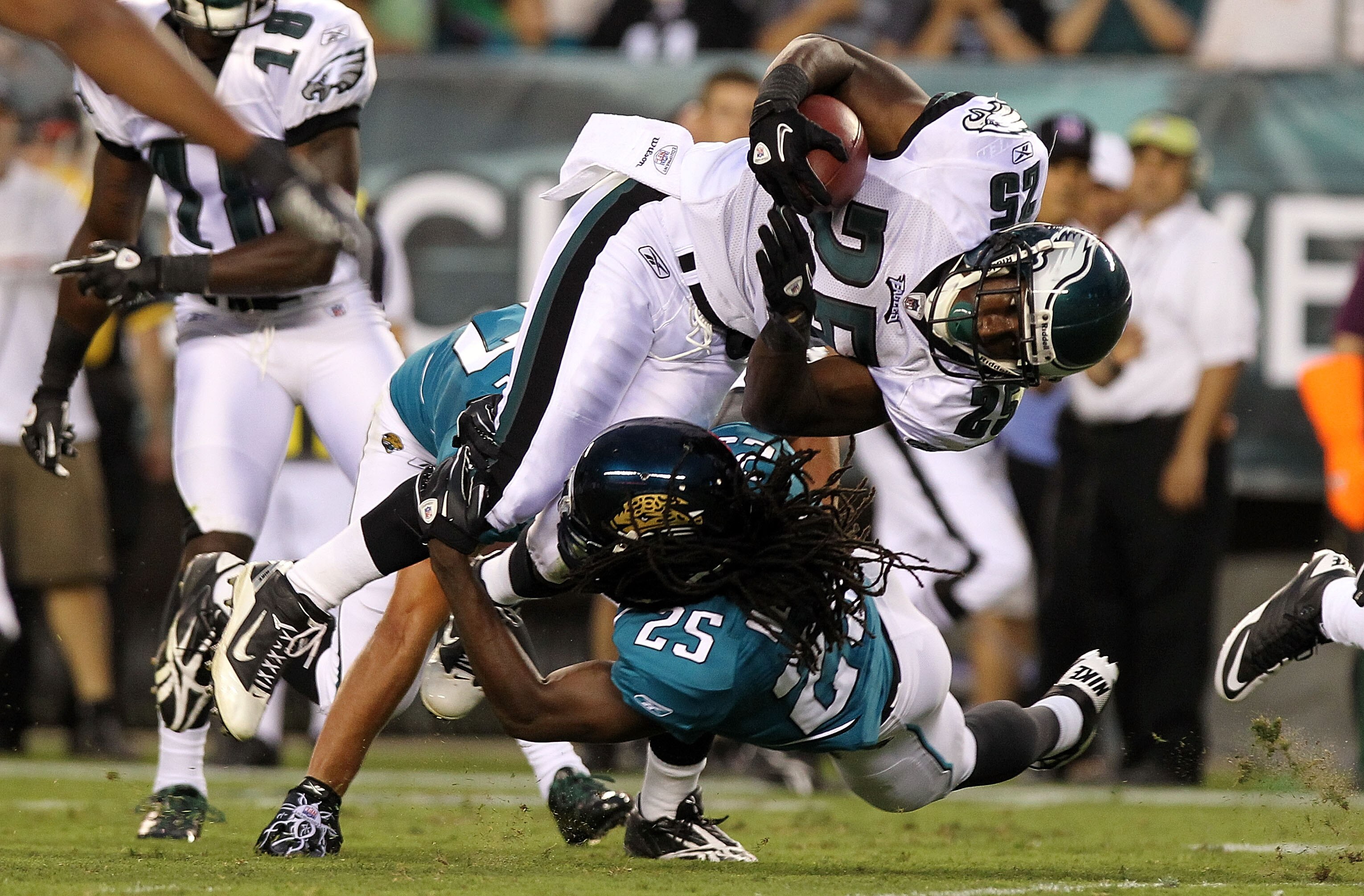 PHILADELPHIA - AUGUST 13: LeSean McCoy #25 of the Philadelphia Eagles is tackled by Reggie Nelson #25 of the Jacksonville Jaguars during their preseason game at Lincoln Financial Field on August 13, 2010 in Philadelphia, Pennsylvania.  (Photo by Nick Laha