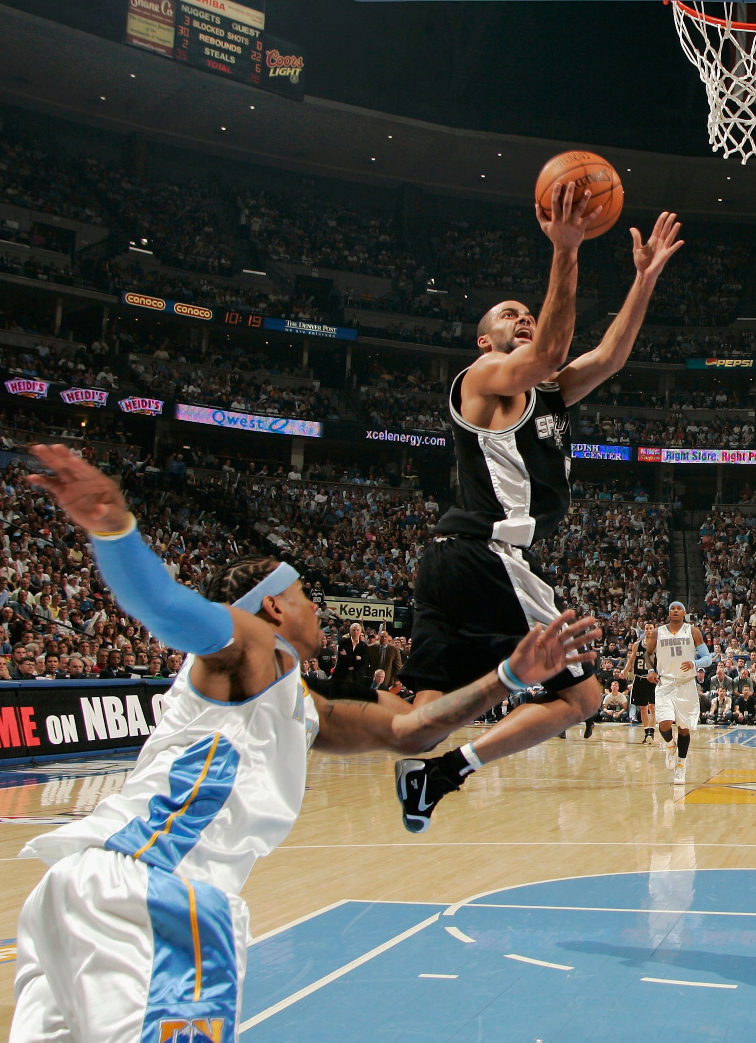 DENVER - APRIL 30:  Tony Parker #9 of the San Antonio Spurs sprints past Carmelo Anthony #15 of the Denver Nuggets to score a basket in the second half of Game Four of the Western Conference Quarterfinals during the 2007 NBA Playoffs at the Pepsi Center o