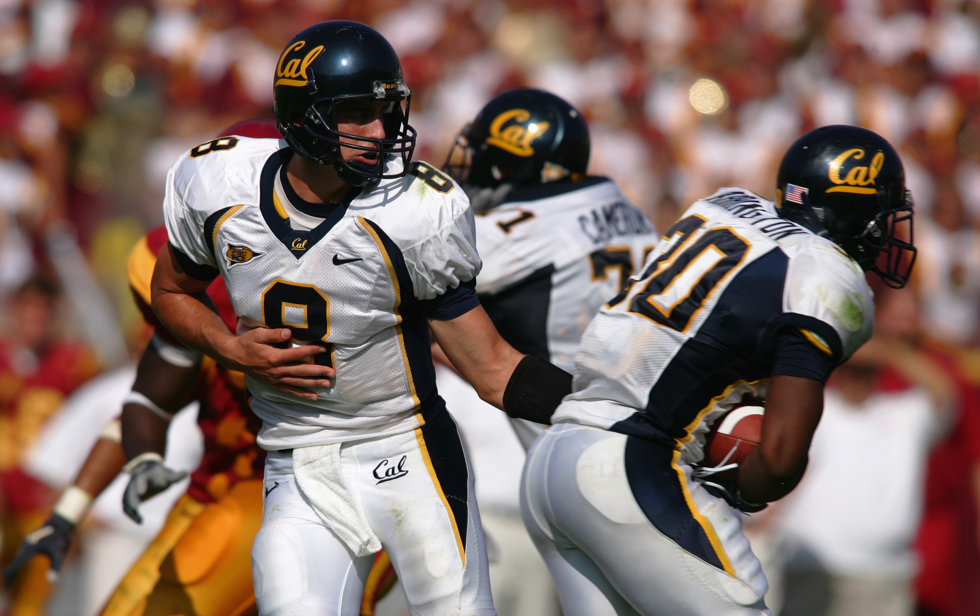 LOS ANGELES - OCTOBER 9:  Aaron Rodgers #8 of the California Golden Bears hands off to running back J.J. Arrington #30 during the game against the USC Trojans on October 9, 2004 at Los Angeles Memorial Coliseum in Los Angeles, California.  The Trojans def