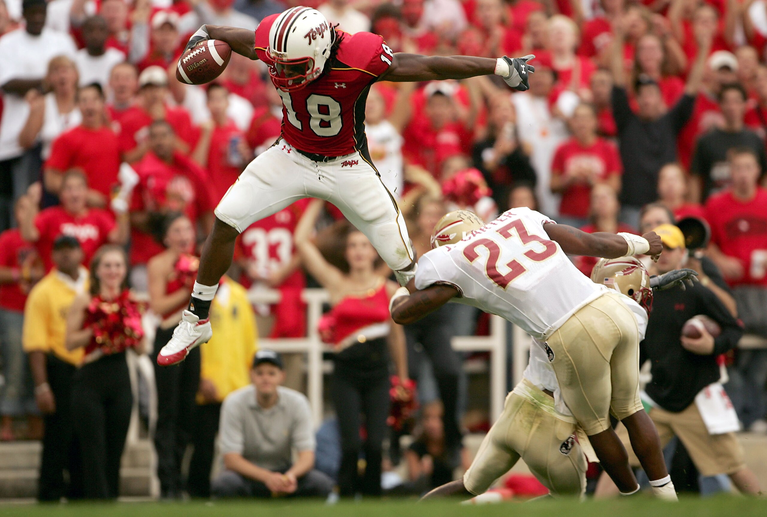 COLLEGE PARK, MD - OCTOBER 30:  Vernon Davis #18 of the University of Maryland Terrapins leaps over the defense of Bryant McFadden #8 and Jerome Carter #23 of the Florida State Seminoles during NCAA football at Byrd Stadium on October 30, 2004 in College