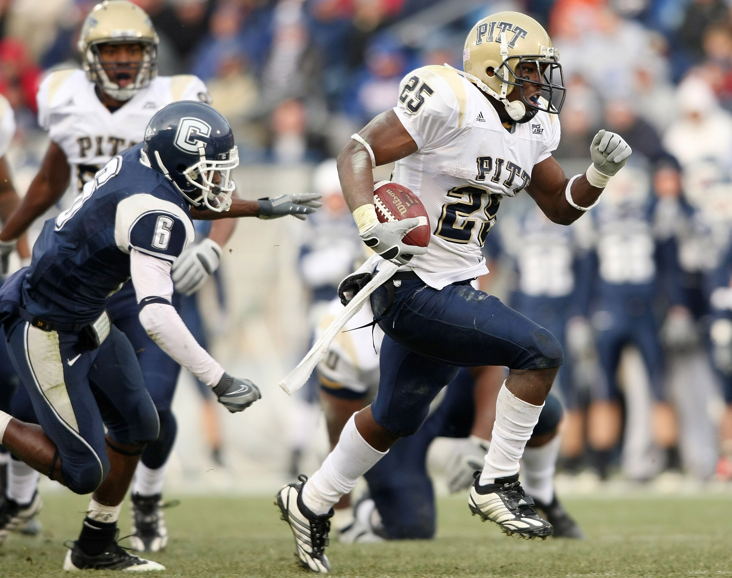 EAST HARTFORD, CT - DECEMBER 06:  LeSean McCoy #25 of the Pittsburgh Panthers breaks free from Jasper Howard #6 of the Connecticut Huskies to carry the ball in for a touchdown on December 6, 2008 at Rentschler Field in East Hartford, Connecticut. The Pant