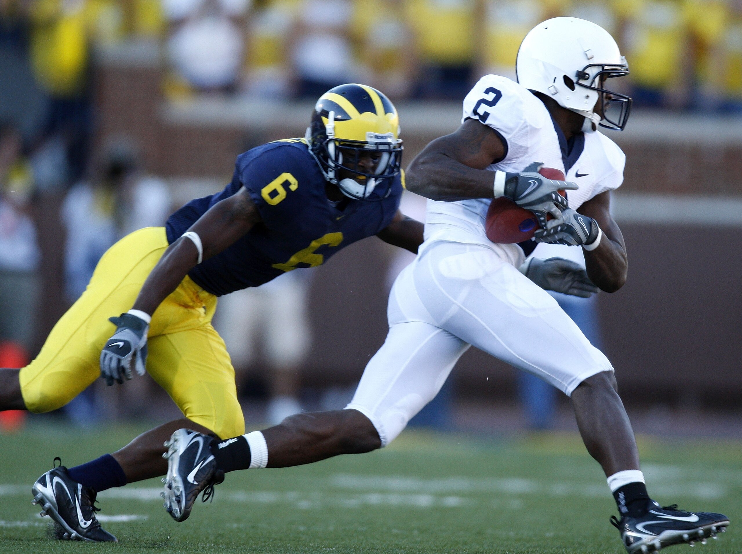 ANN ARBOR, MI - SEPTEMBER 22:  Derrick Williams #2 of the Penn State Nittany Lions outrun the tackle of Donovan Warren #6 of the Michigan Wolverines at Michigan Stadium September 22, 2007 in Ann Arbor, Michigan. Michigan won the game 14-9.  (Photo by Greg