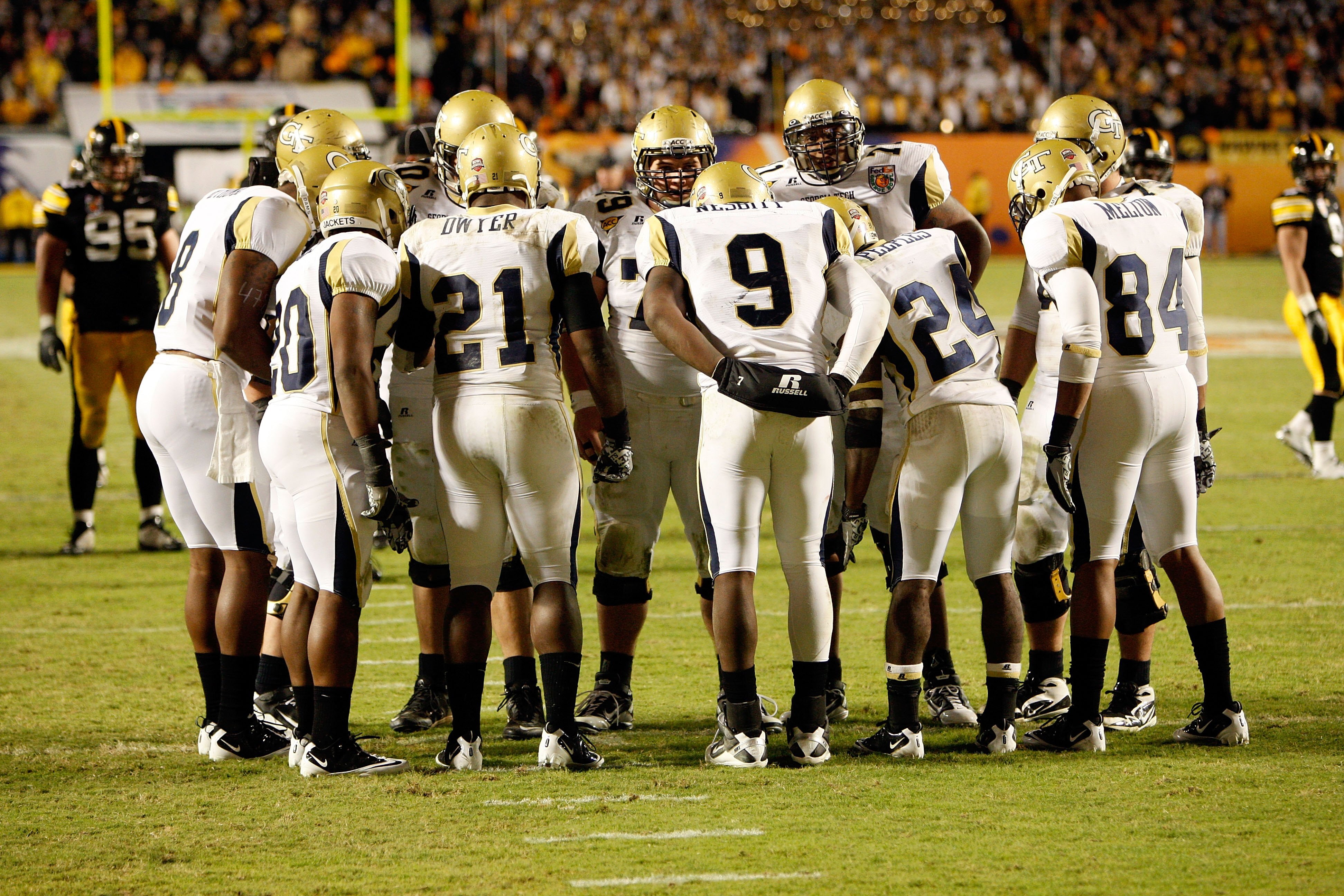 MIAMI GARDENS, FL - JANUARY 05:  Quarterback Josh Nesbitt #9 of the Georgia Tech Yellow Jackets huddles with his teammates on offense against the Iowa Hawkeyes during the FedEx Orange Bowl at Land Shark Stadium on January 5, 2010 in Miami Gardens, Florida