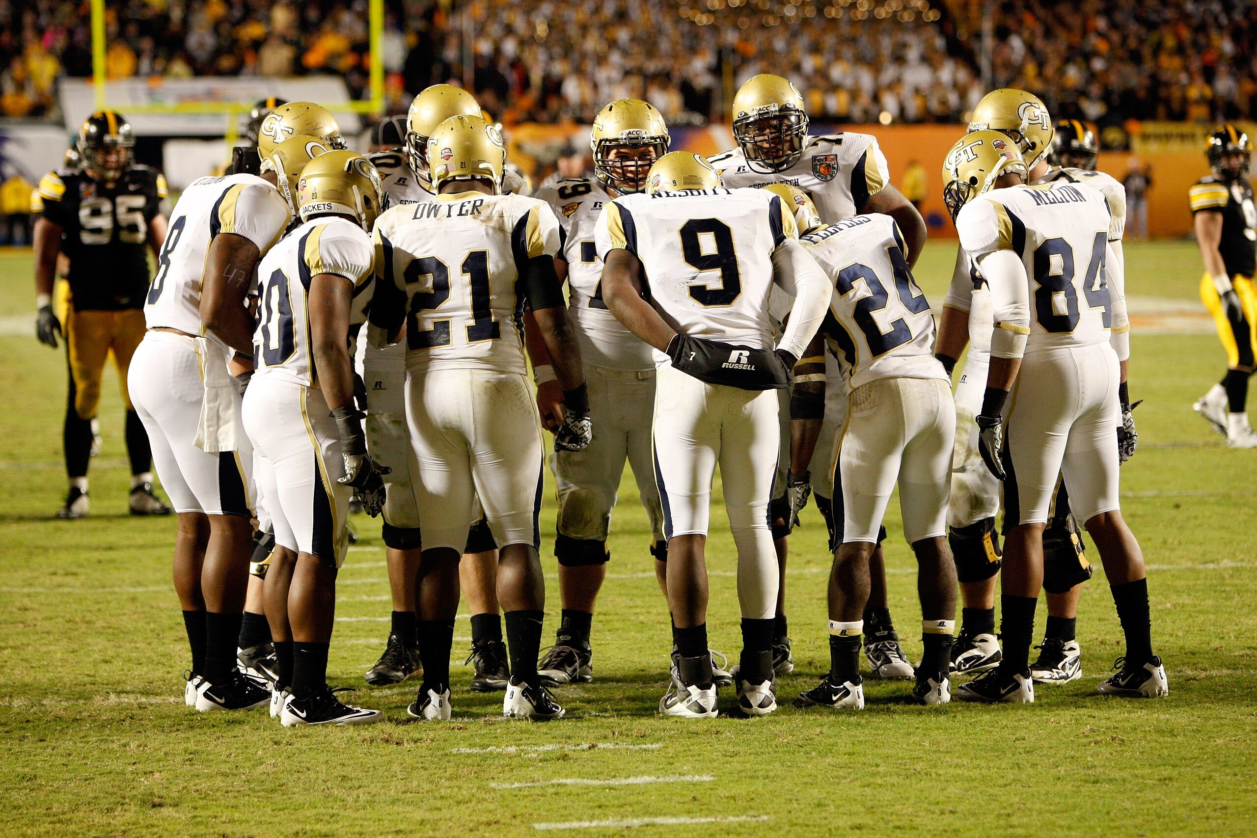 MIAMI GARDENS, FL - JANUARY 05:  Quarterback Josh Nesbitt #9 of the Georgia Tech Yellow Jackets huddles with his teammates on offense against the Iowa Hawkeyes during the FedEx Orange Bowl at Land Shark Stadium on January 5, 2010 in Miami Gardens, Florida