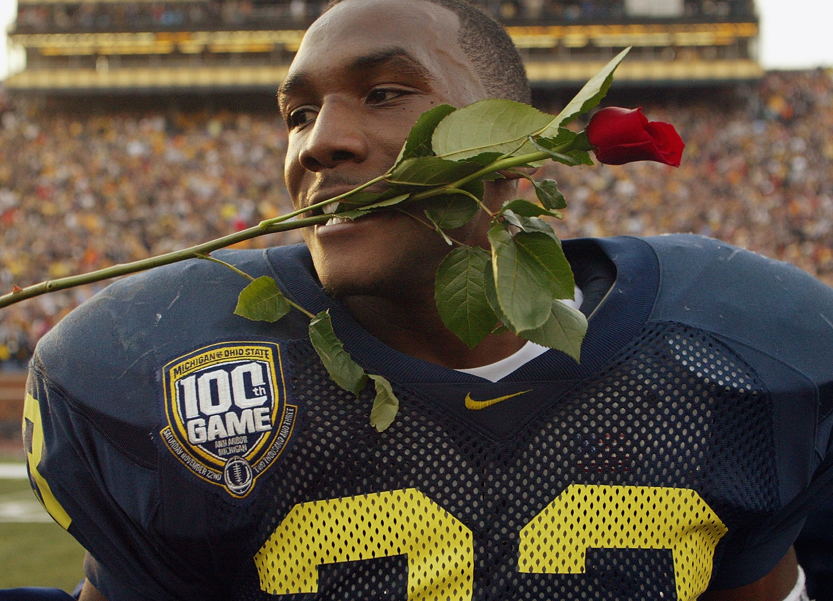 ANN ARBOR, MI - NOVEMBER 22:  Running back Chris Perry #23 of the Michigan Wolverines celebrates by putting a rose in his mouth after the victory against the Ohio State Buckeyes during the 100th meeting of the two teams November 22, 2003 at Michigan Stadi