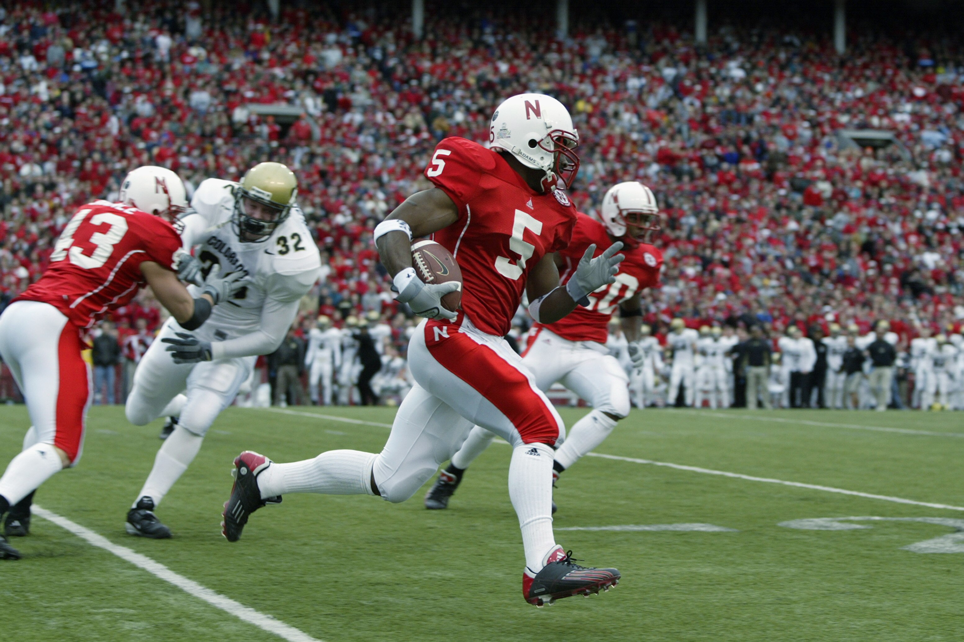 LINCOLN, NE - NOVEMBER 29:  Cornerback DeJuan Groce #5 of the University of Nebraska Cornhuskers runs with the ball during the NCAA game against the University of Colorado Buffaloes at Memorial Stadium on November 29, 2002 in Lincoln, Nebraska.  Colorado