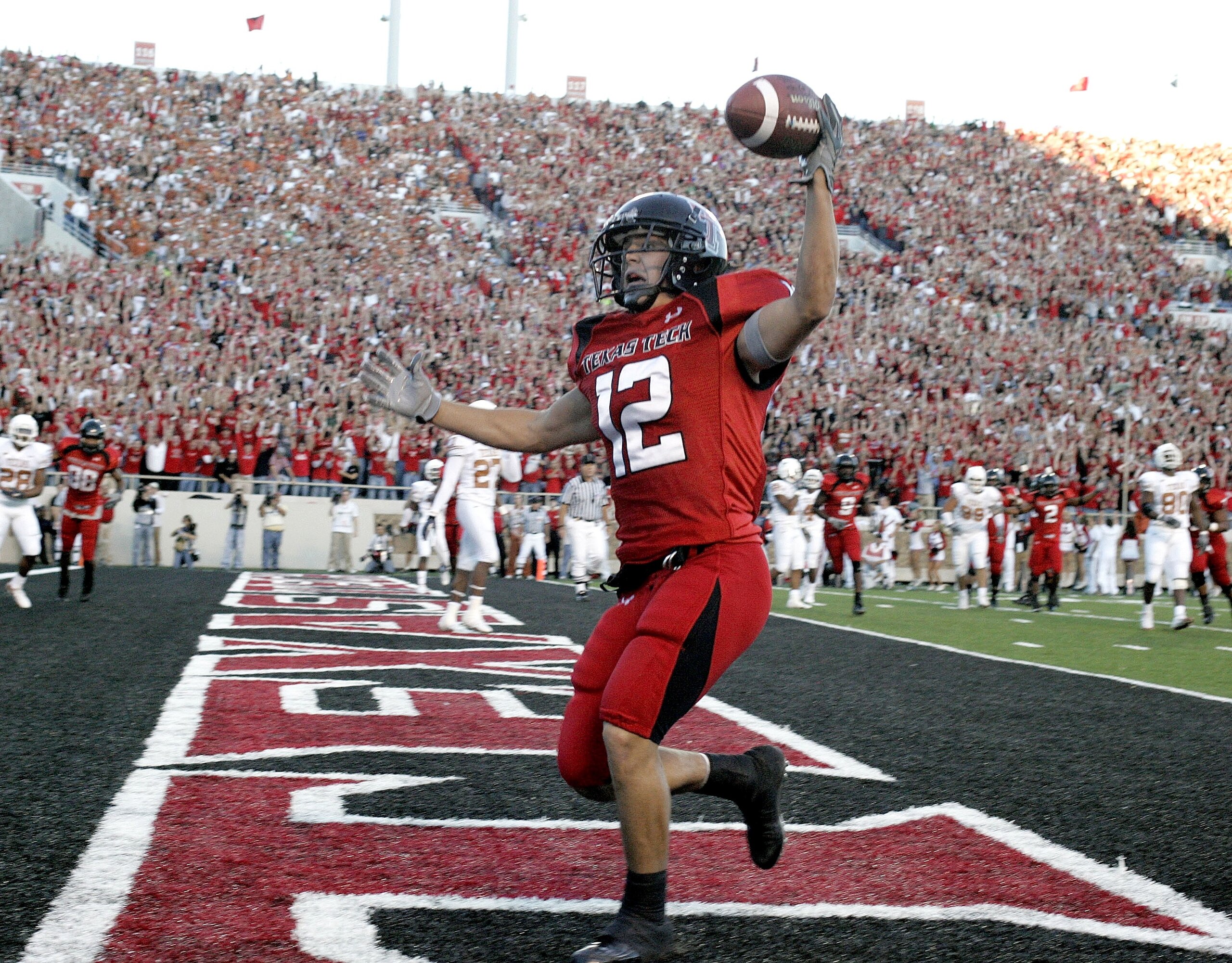 LUBBOCK, TX-OCTOBER 28: Eric Morris #12 of the Texas Tech Red Raiders catches a touchdown pass against the Texas Longhorns  at Jones AT&T Stadium on October 28, 2006 in Lubbock, Texas. (Photo by Layne Murdoch/Getty Images)