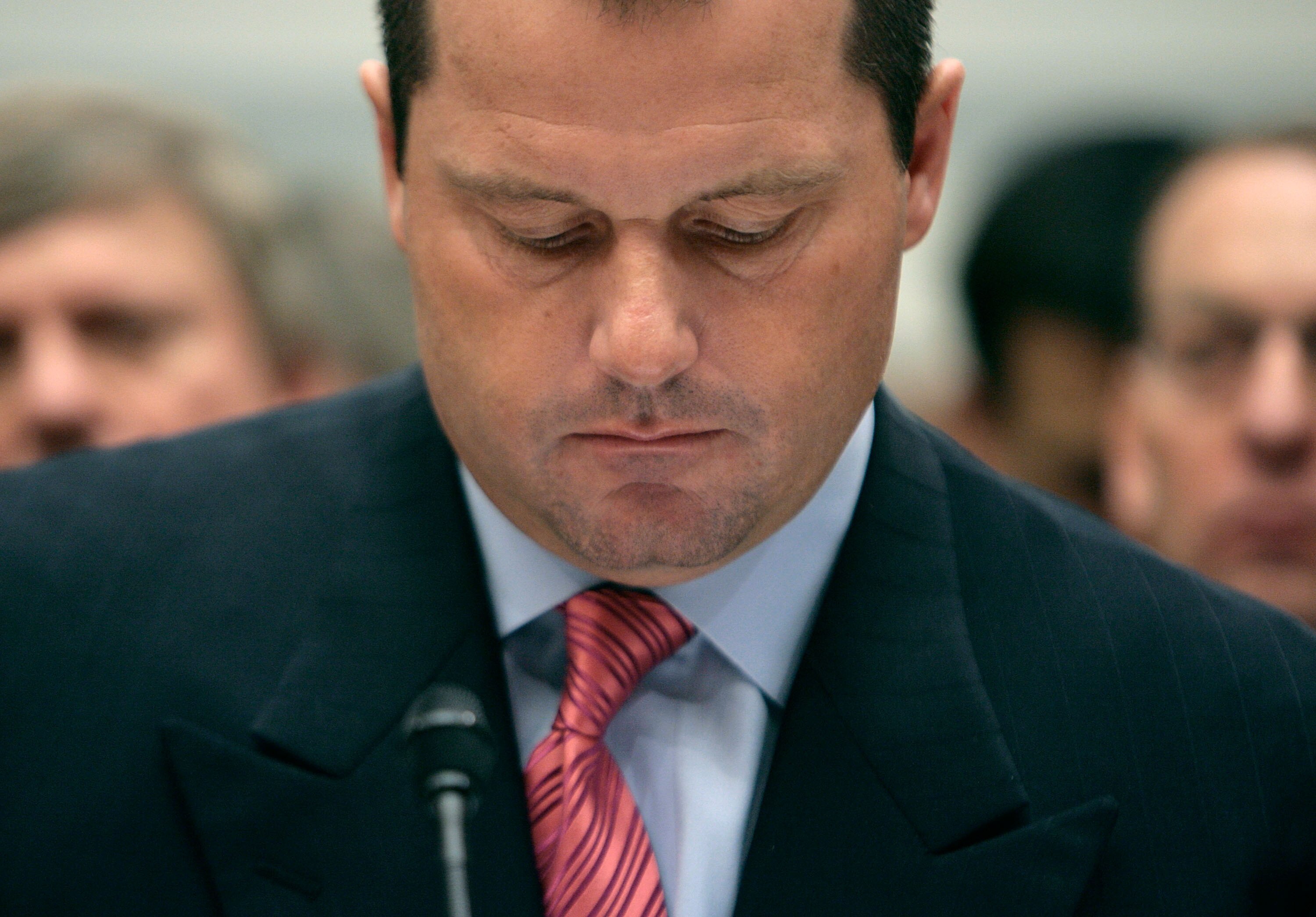 WASHINGTON - FEBRUARY 13:  Major League Baseball pitcher Roger Clemens looks over his papers during a U.S. House Oversight and Government Reform Committee hearing on Capitol Hill February 13, 2008 in Washington, DC. The 'Mitchell Report' named several for