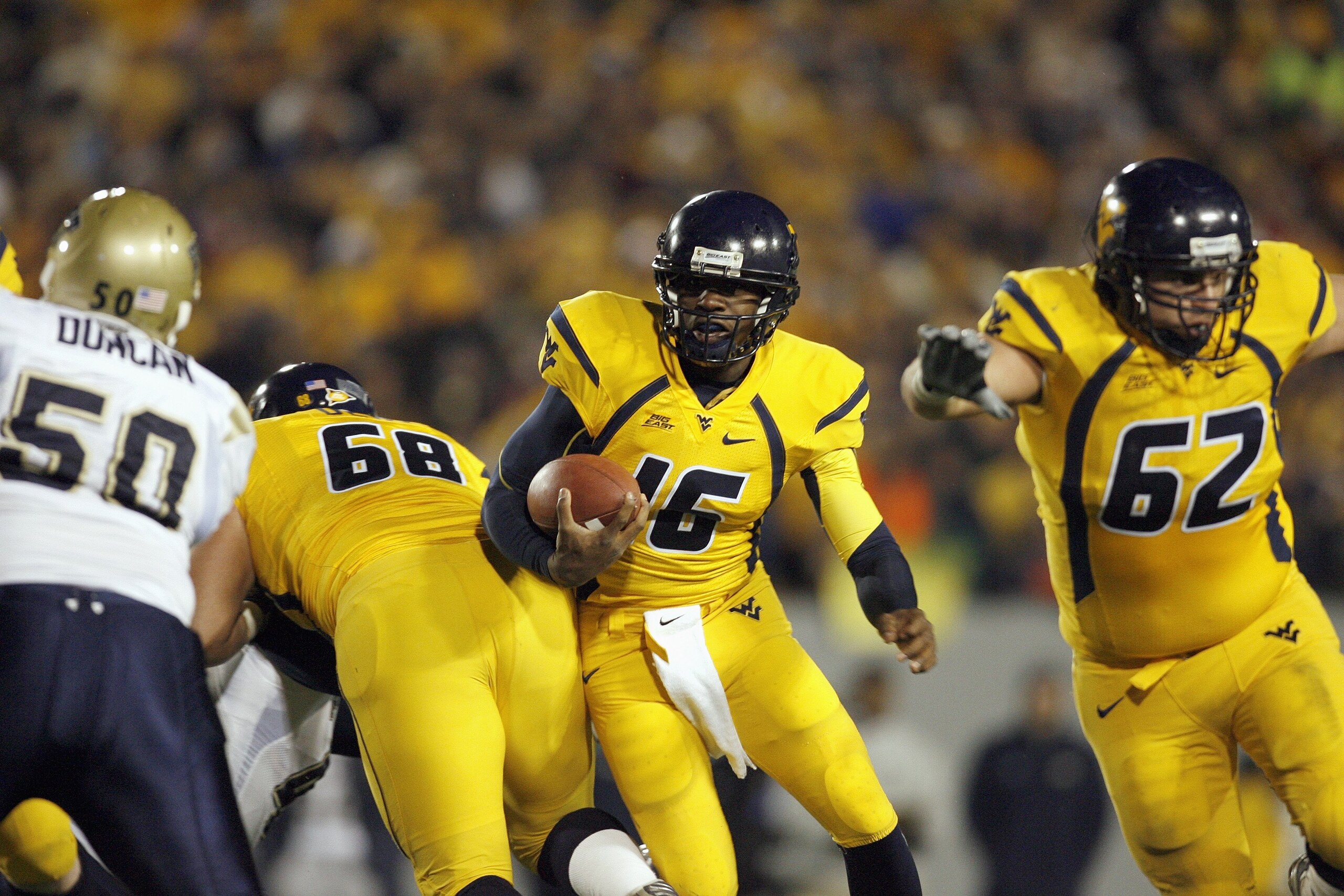 MORGANTOWN, WV - DECEMBER 1: Jarrett Brown #16 of the West Virginia Mountaineers carries the ball during the game against the Pittsburgh Panthers at Milan Puskar Stadium on December 1, 2007 in Morgantown, West Virginia. (Photo by Kevin C. Cox/Getty Images