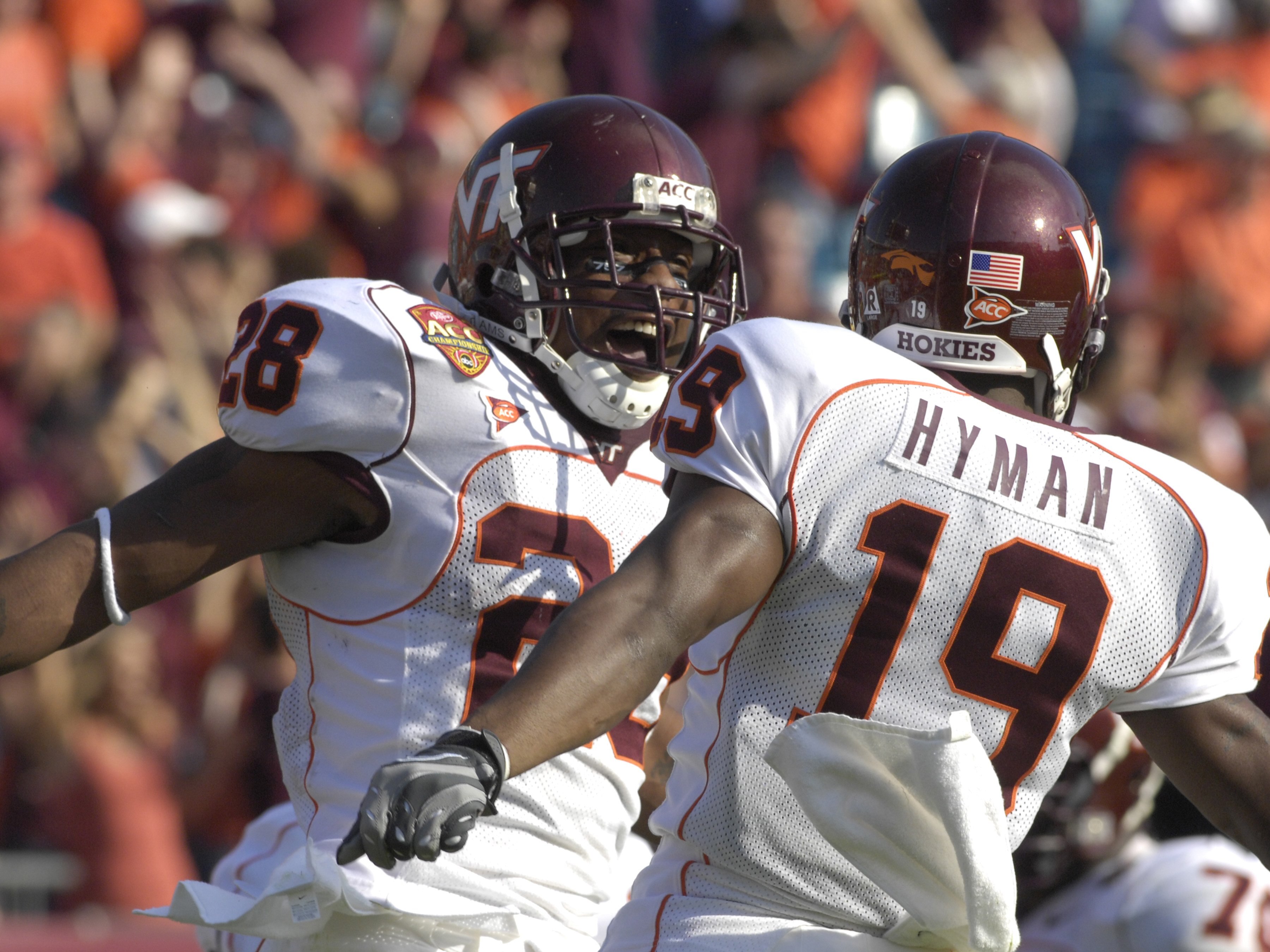JACKSONVILLE, FL - DECEMBER 1: Running back Branden Ore #28 and split end Josh Hyman #19 of the Virginia Tech Hokies celebrate a score against the Boston College Eagles in the ACC Championship Game at Jacksonville Municipal Stadium on December 1, 2007 in