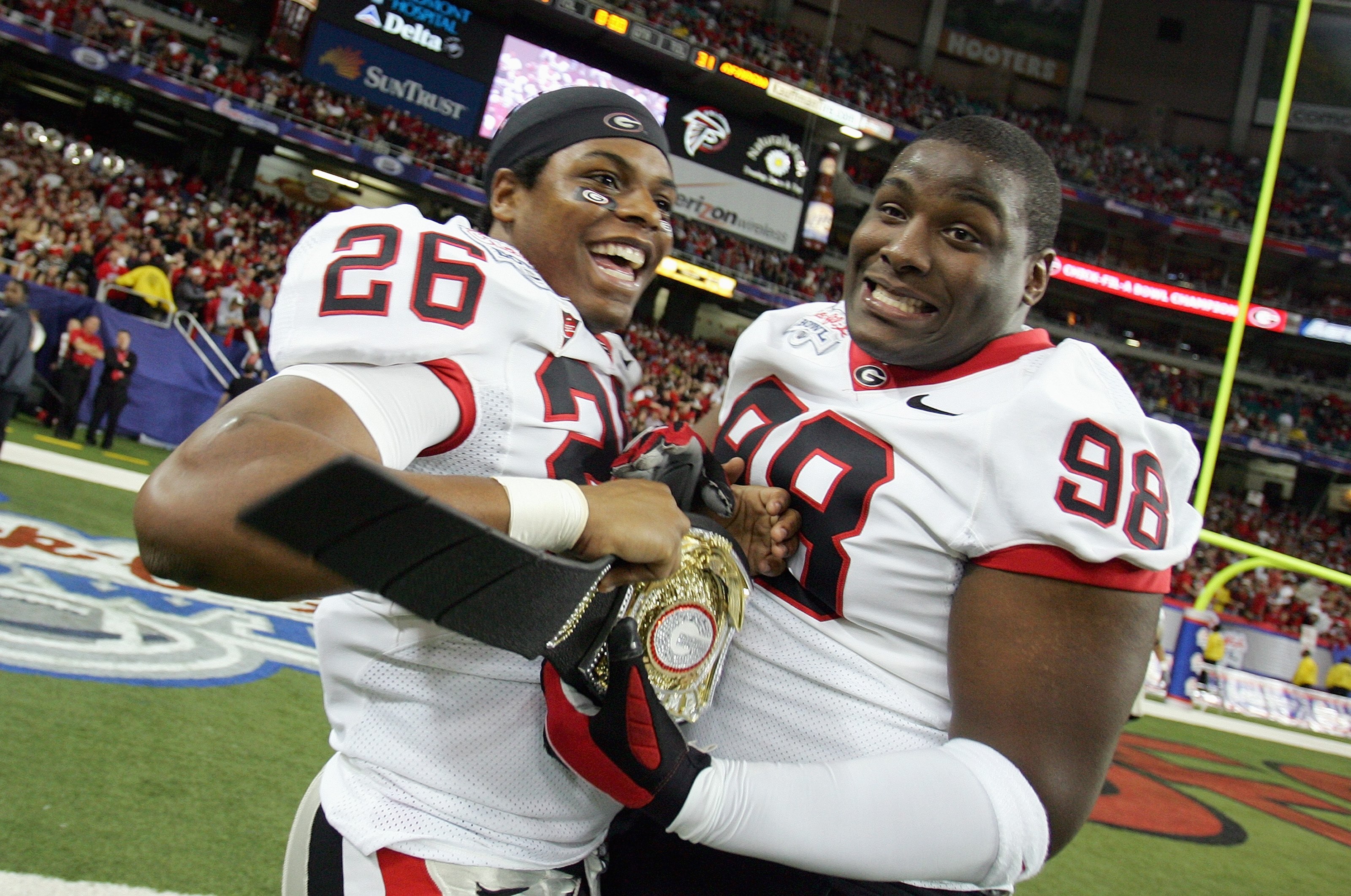 ATLANTA - DECEMBER 30: Brian Mimbs #26 of the Georgia Bulldogs celebrates with Ricardo Crawford #98 after a 31-24 victory over the Virginia Tech Hokies during the Chick-fil-a Bowl on December 30, 2006 at the Georgia Dome in Atlanta, Georgia. (Photo by Str
