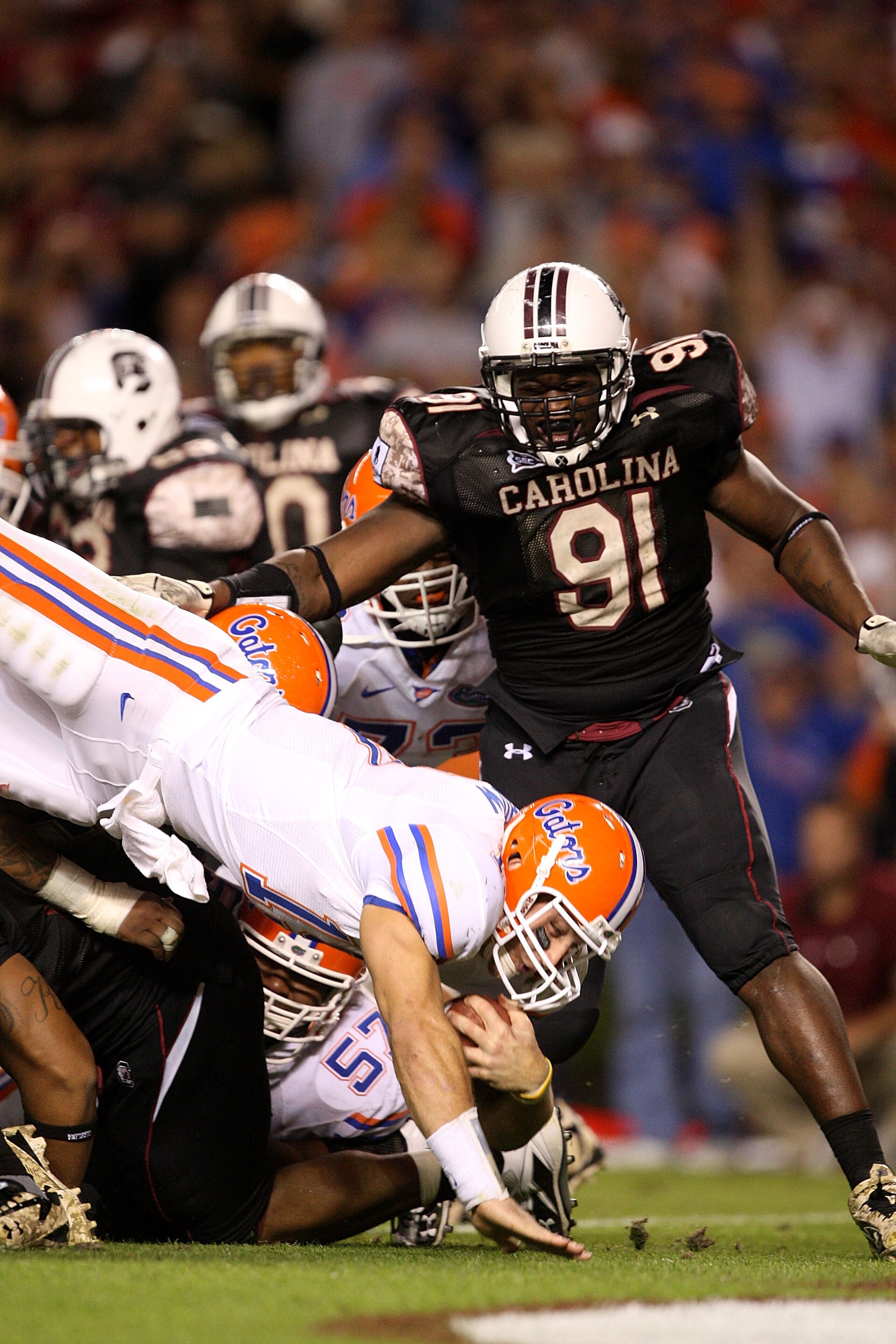 COLUMBIA, SC - NOVEMBER 14: Tim Tebow #15 of the Florida Gators dives in for a touchdown as Ladi Ajiboye #91 of the South Carolina Gamecocks watches during their game at Williams-Brice Stadium on November 14, 2009 in Columbia, South Carolina. (Photo by COLUMBIA, SC - NOVEMBER 14: Tim Tebow #15 of the Florida Gators dives in for a touchdown as Ladi Ajiboye #91 of the South Carolina Gamecocks watches during their game at Williams-Brice Stadium on November 14, 2009 in Columbia, South Carolina. (Photo by