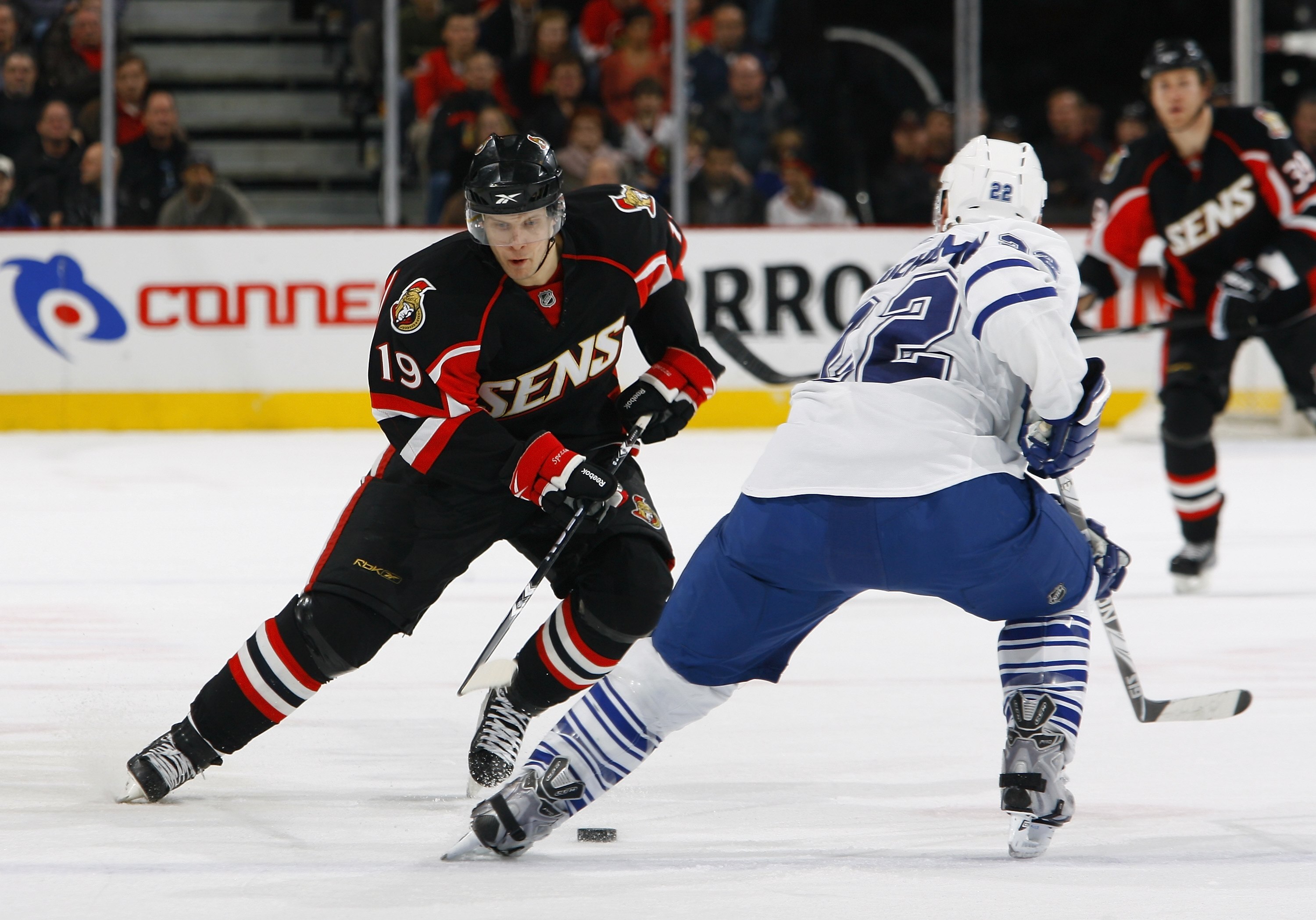 OTTAWA, ON - MARCH 06:  Jason Spezza #19 of the Ottawa Senators skates with the puck against Francois Beauchemin #22 of the Toronto Maple Leafs in a game at Scotiabank Place on March 6, 2010 in Ottawa, Canada.  (Photo by Phillip MacCallum/Getty Images)