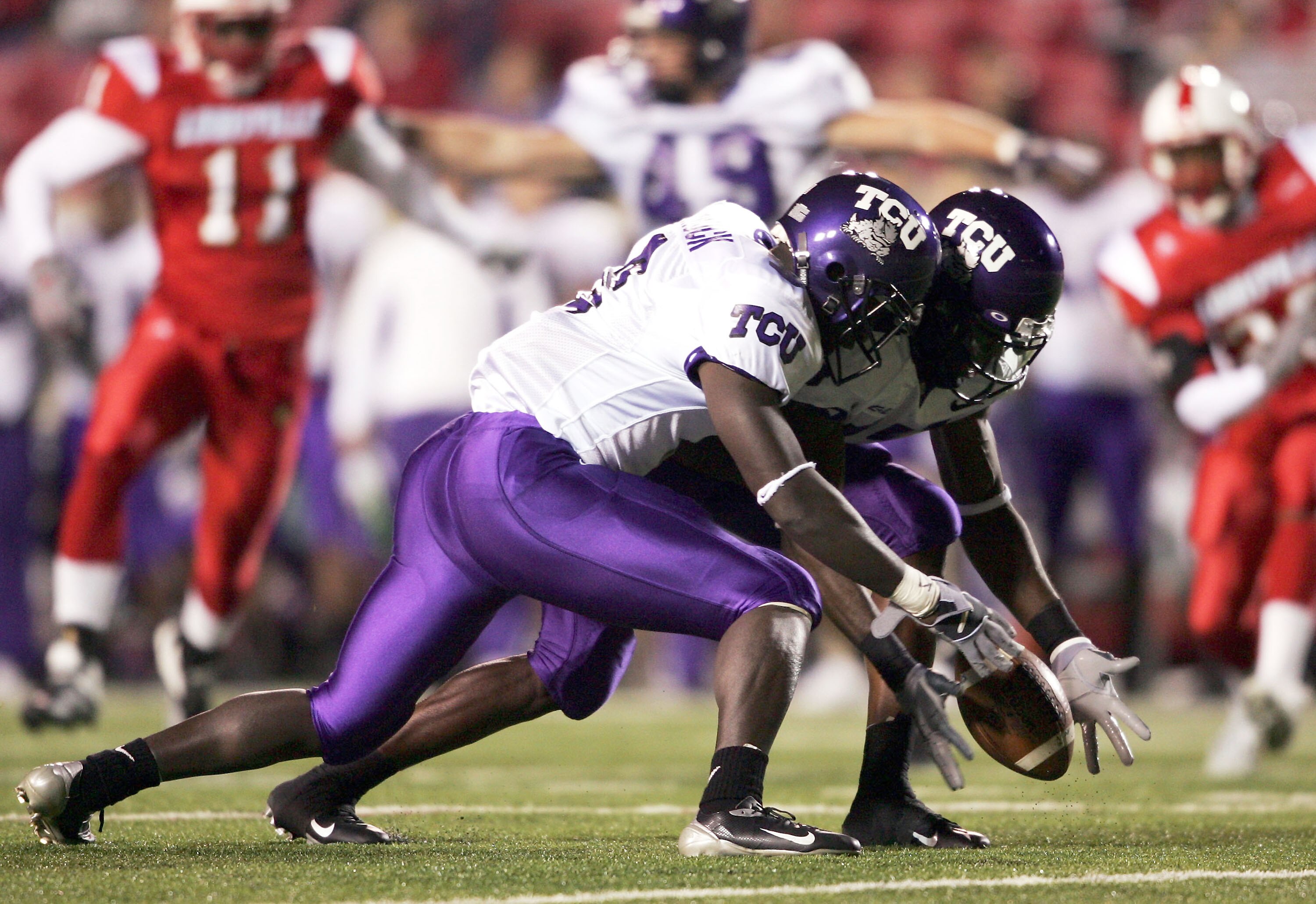 LOUISVILLE, KY - NOVEMBER 10:  Wide receivers Marcus Brock #3 and Cory Rodgers #17 of TCU try to recover a fumble in a game against Louisville at Papa John's Cardinal Stadium on November 10, 2004 in Louisville, Kentucky.  (Photo by Andy Lyons/Getty Images