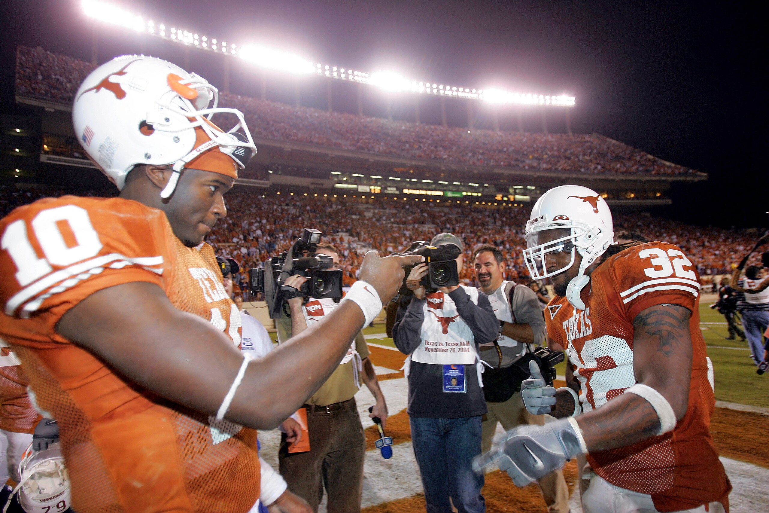 AUSTIN, TX - NOVEMBER 26:  Quarterback Vince Young #10 and running back Cedric Benson #32 of the University of Texas Longhorns celebrate after defeating the Texas A&M University Aggies 26-13 on November 26, 2004 at Royal Memorial Stadium in Austin, Texas.