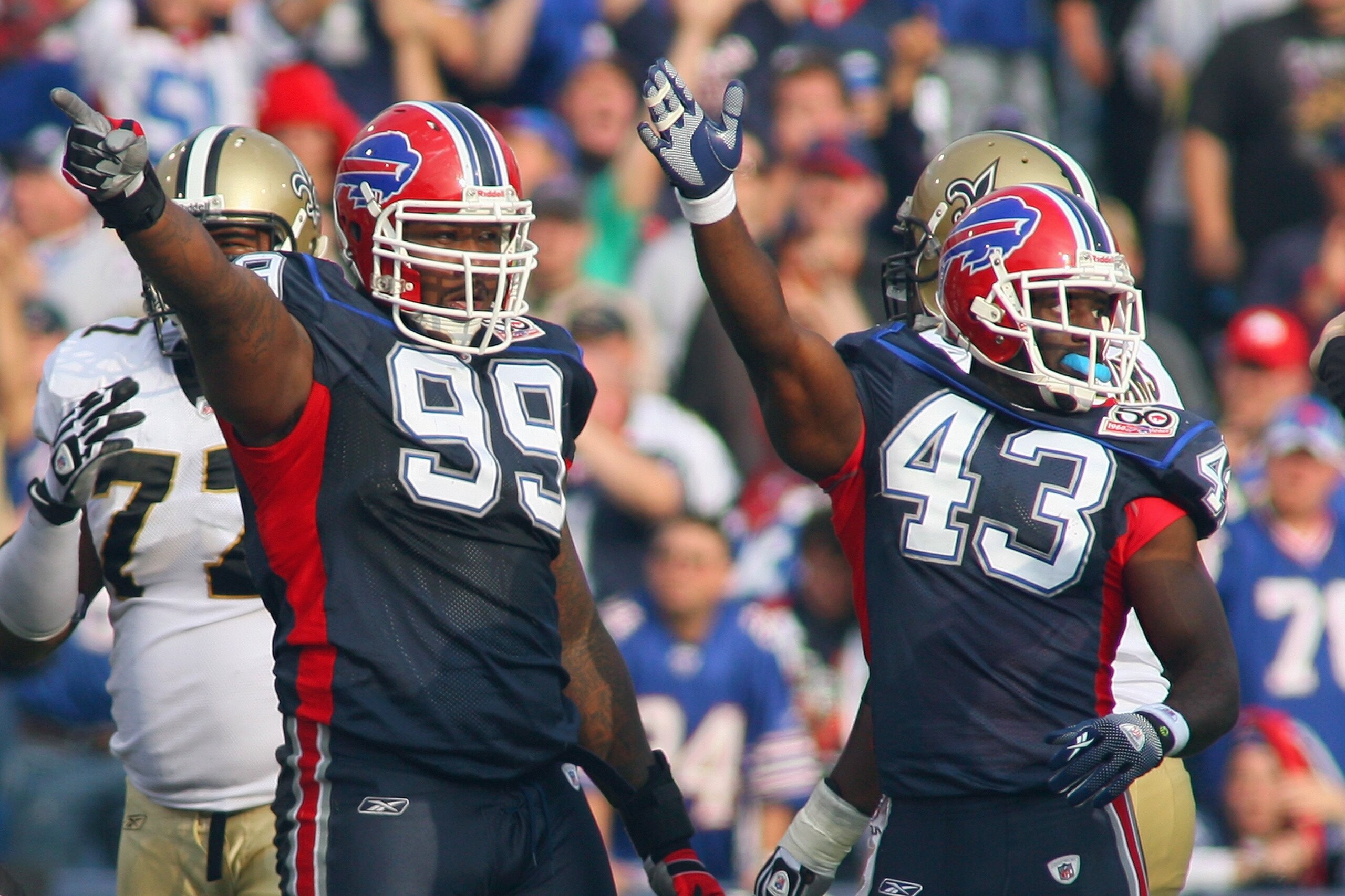 ORCHARD PARK, NY - SEPTEMBER 27: Marcus Stroud #99 and Bryan Scott #43 of the Buffalo Bills motions for possession during the game against the New Orleans Saints at Ralph Wilson Stadium on September 27, 2009 in Orchard Park, New York. (Photo by Rick Stewa