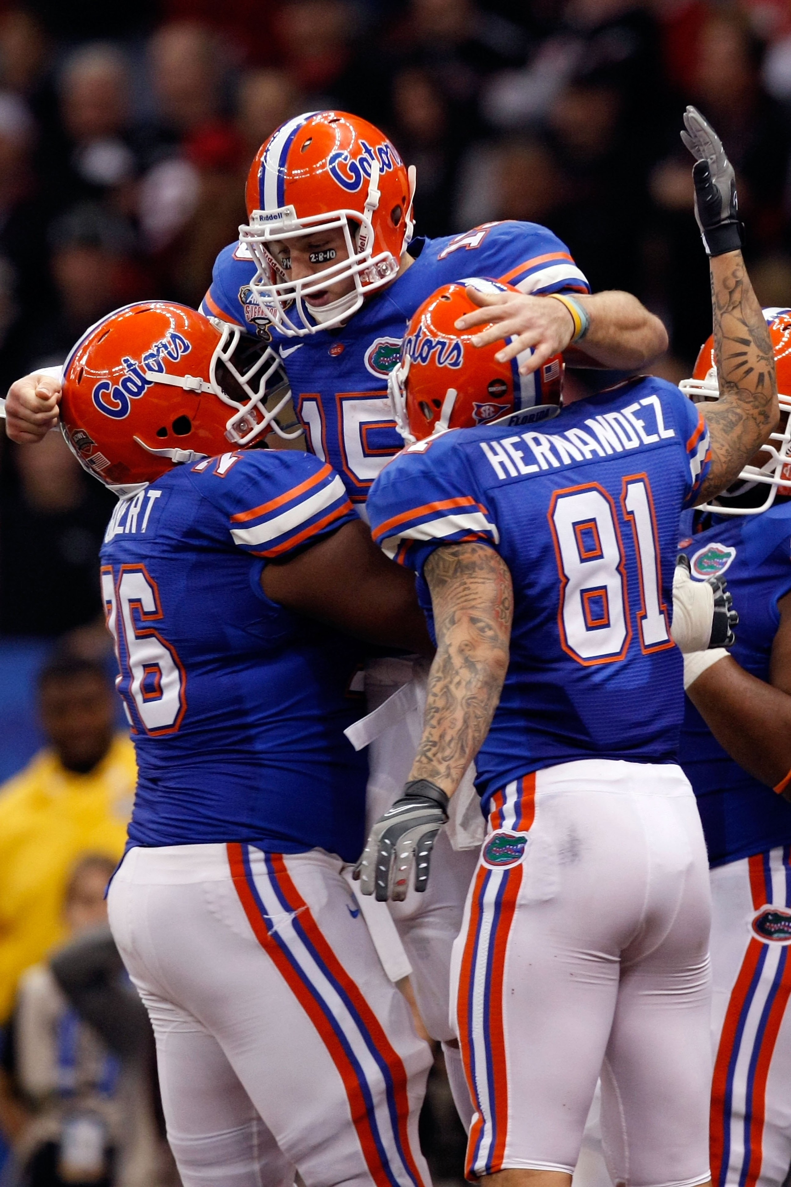 NEW ORLEANS - JANUARY 01: Tim Tebow #15 of the Florida Gators hugs his teammates Marcus Gilbert #76 and Aaron Hernandez #81 after scoring a touchdown against the Cincinnati Bearcats during the Allstate Sugar Bowl at the Louisana Superdome on January 1, 2 NEW ORLEANS - JANUARY 01: Tim Tebow #15 of the Florida Gators hugs his teammates Marcus Gilbert #76 and Aaron Hernandez #81 after scoring a touchdown against the Cincinnati Bearcats during the Allstate Sugar Bowl at the Louisana Superdome on January 1, 2