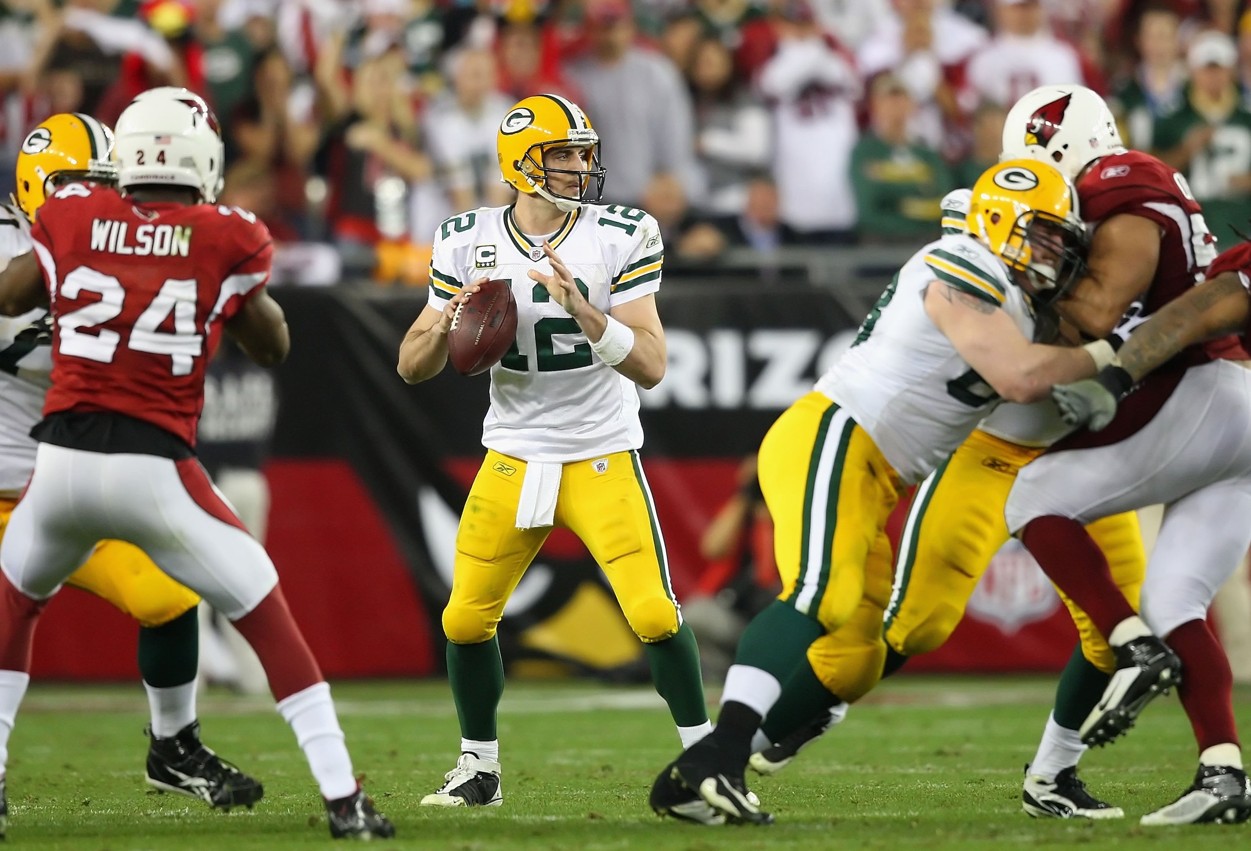 GLENDALE, AZ - JANUARY 10:  Quarterback Aaron Rodgers #12 of the Green Bay Packers drops back to pass during the 2010 NFC wild-card playoff game against the Arizona Cardinals at the Universtity of Phoenix Stadium on January 10, 2010 in Glendale, Arizona. 