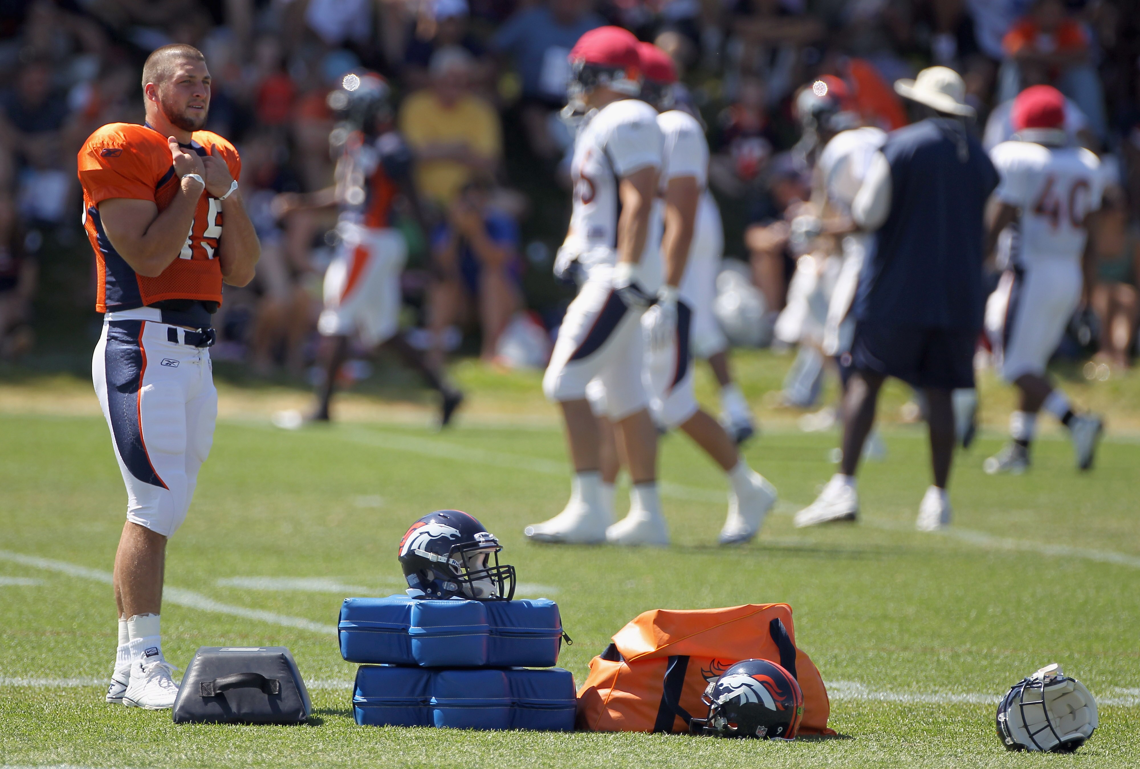 ENGLEWOOD, CO - AUGUST 18:  Rookie quarterback Tim Tebow #15 of the Denver Broncos looks on during training camp practice at Dove Valley on August 18, 2010 in Englewood, Colorado.  (Photo by Doug Pensinger/Getty Images)