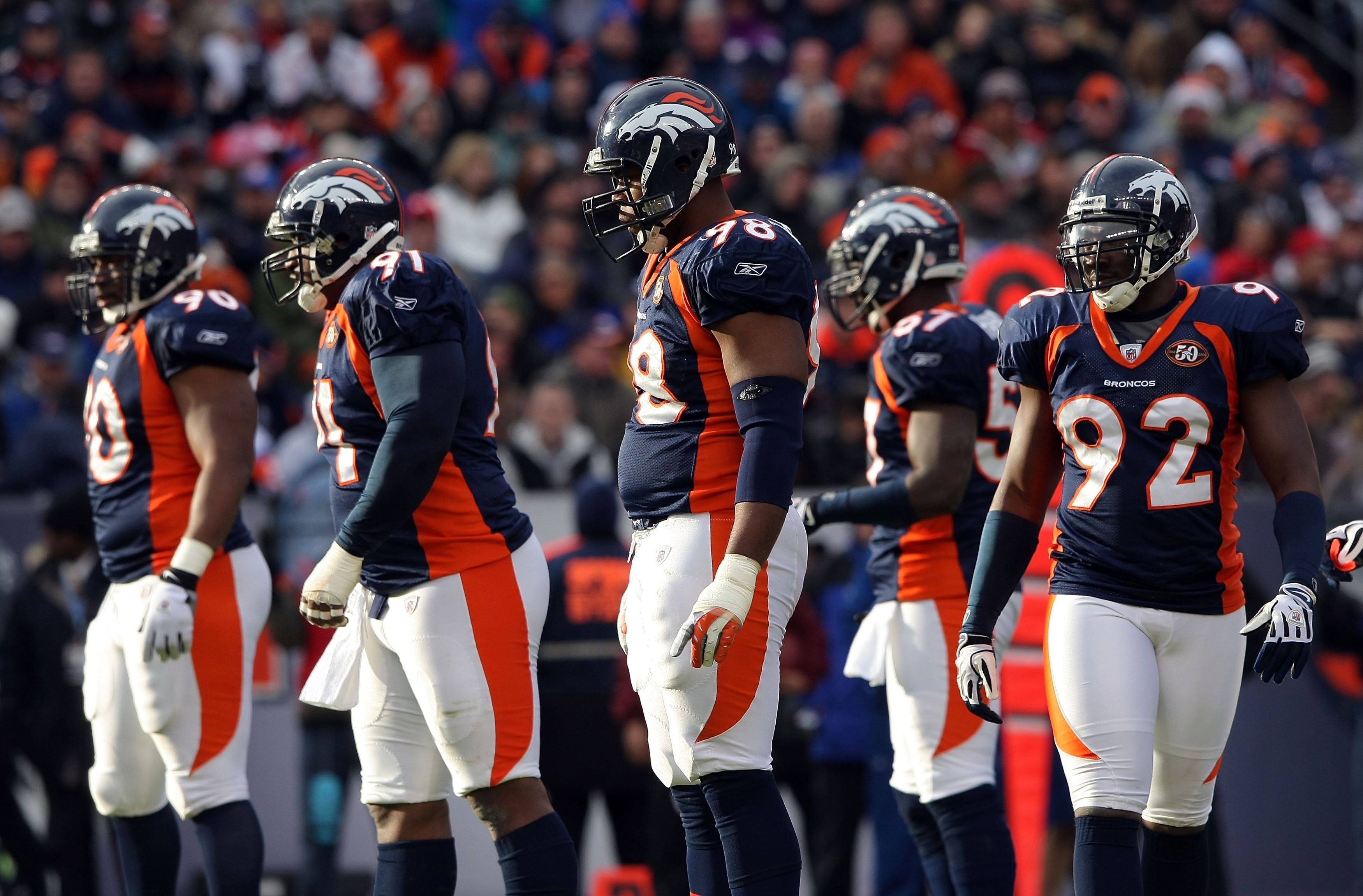 DENVER - JANUARY 03:  (L-R) Kenny Peterson #90, Ronald Fields #91, Ryan McBean #98 and Elvis Dumervil #92 of the Denver Broncos defense prepare for action against the Kansas City Chiefs during NFL action at Invesco Field at Mile High on January 3, 2010 in