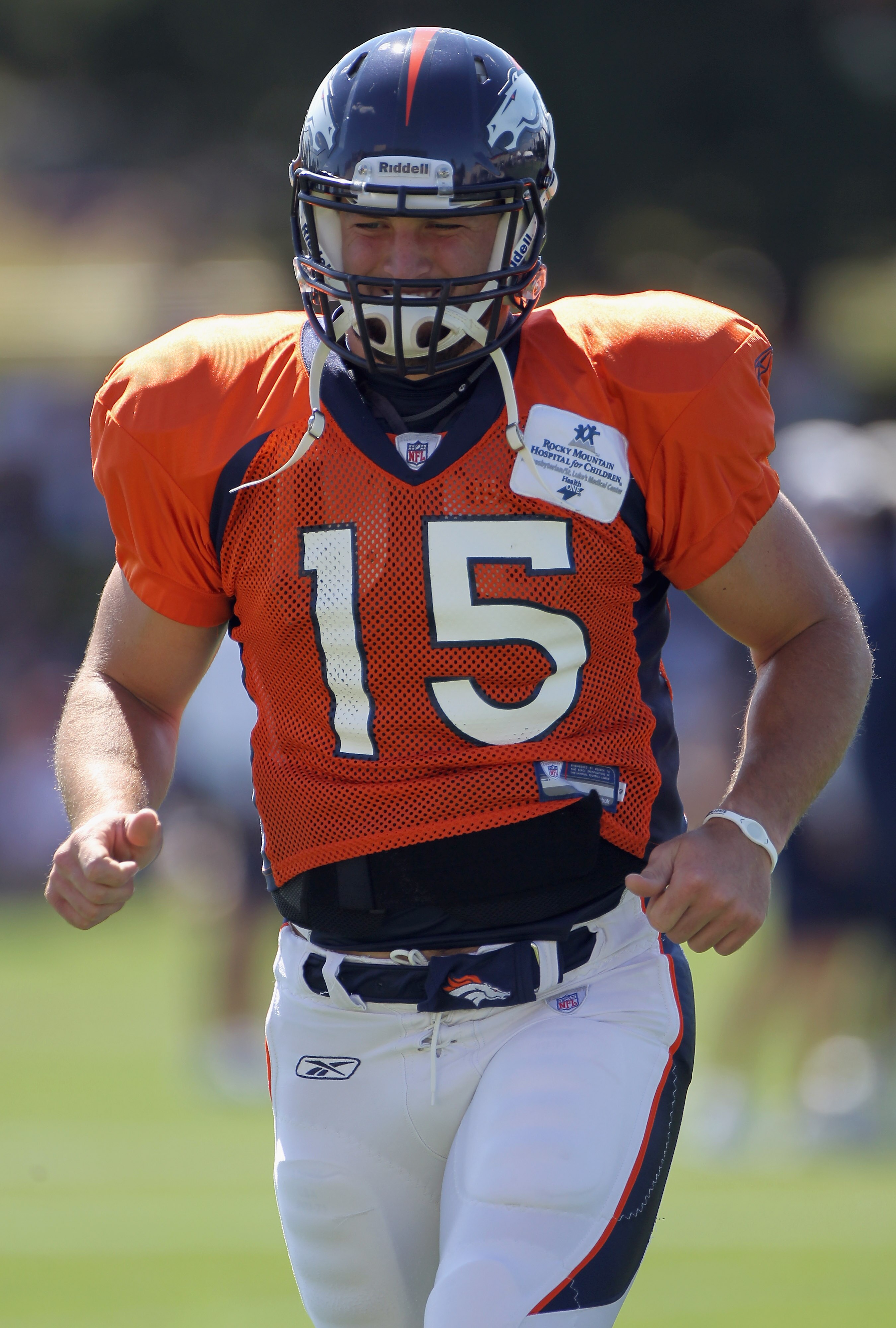 ENGLEWOOD, CO - AUGUST 18:  Rookie quarterback Tim Tebow #15 of the Denver Broncos leaves the field and heads for the locker room during the early sessions of practice at Dove Valley on August 18, 2010 in Englewood, Colorado.  (Photo by Doug Pensinger/Get