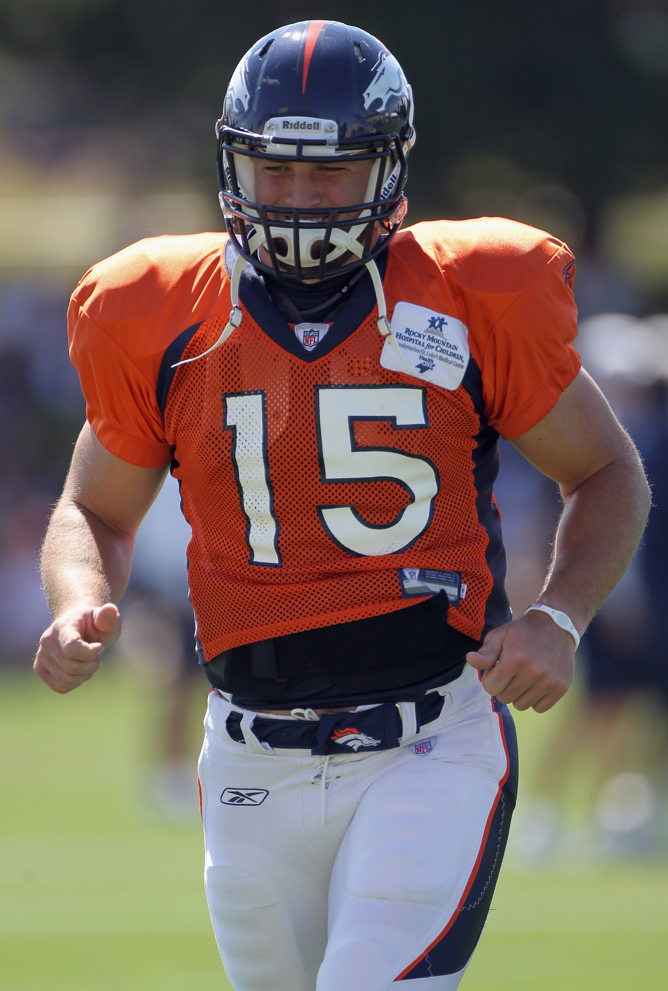 ENGLEWOOD, CO - AUGUST 18:  Rookie quarterback Tim Tebow #15 of the Denver Broncos leaves the field and heads for the locker room during the early sessions of practice at Dove Valley on August 18, 2010 in Englewood, Colorado.  (Photo by Doug Pensinger/Get