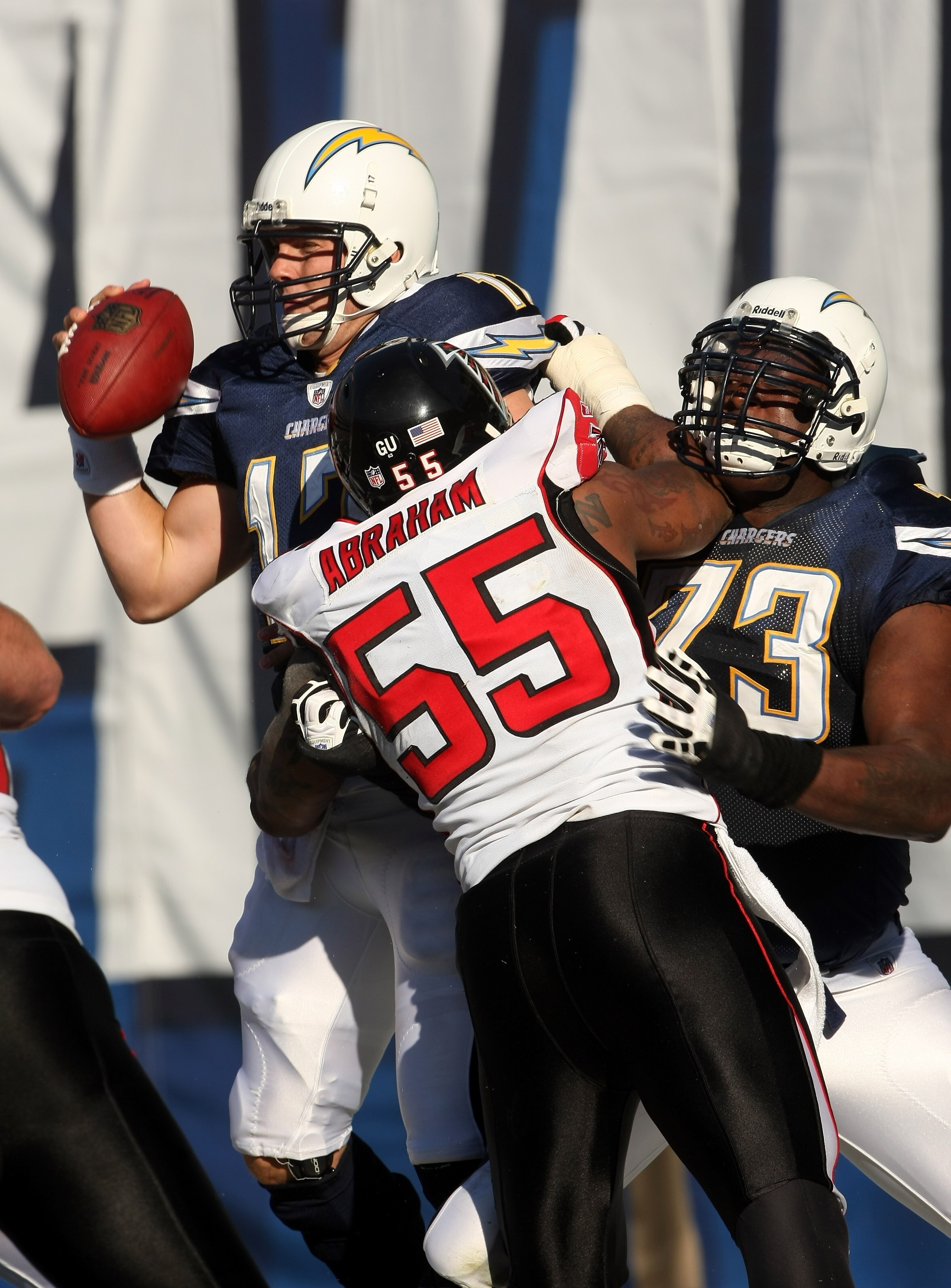SAN DIEGO - NOVEMBER 30: Linebacker John Abraham #55 of the Atlanta Falcons hits quarterback Philip Rivers #17 of the San Diego Chargers in th end zone as offensive tackle Marcus McNeill blocks on November 30, 2008 at Qualcomm Stadium in San Diego, Califo