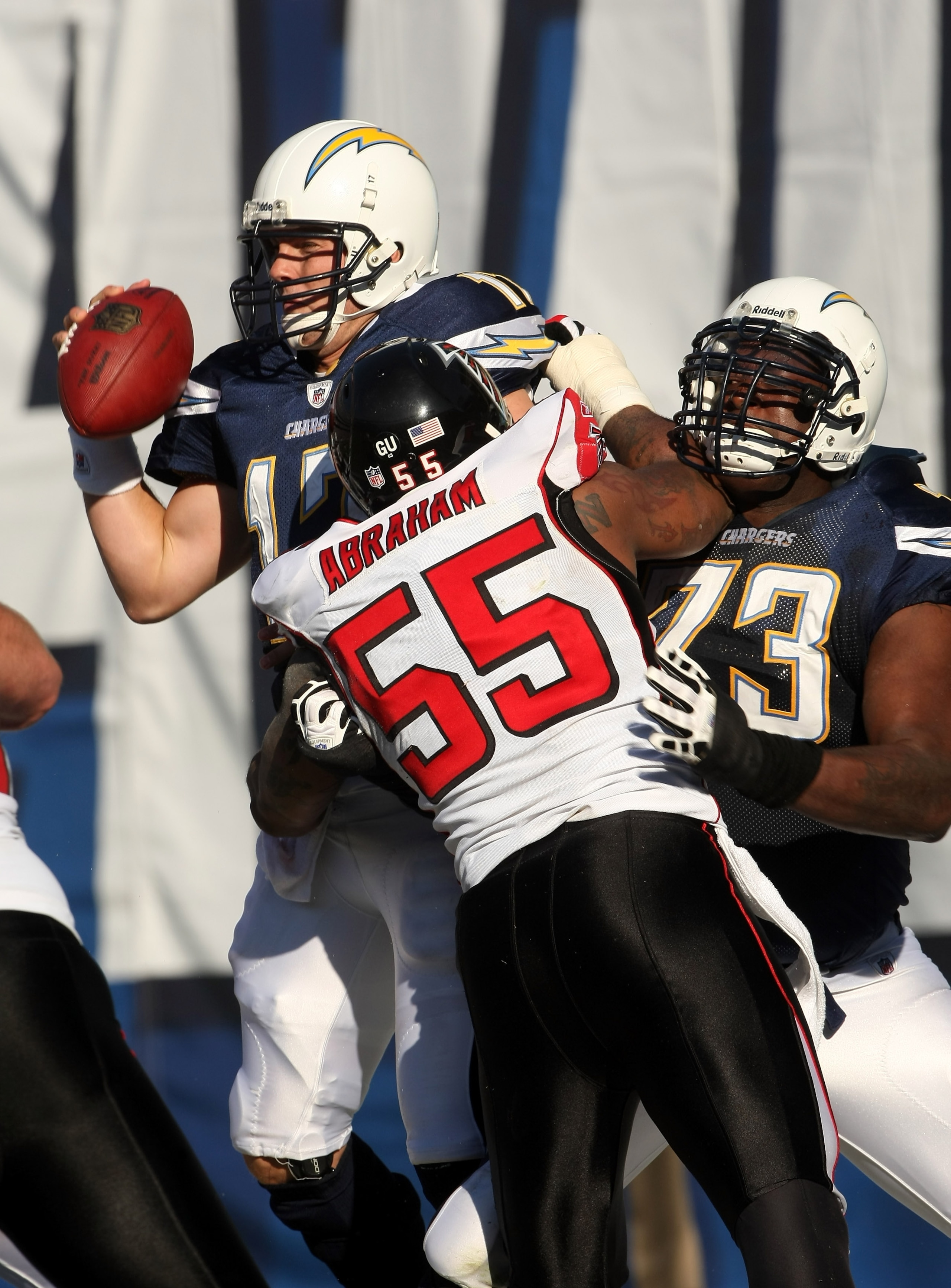 SAN DIEGO - NOVEMBER 30: Linebacker John Abraham #55 of the Atlanta Falcons hits quarterback Philip Rivers #17 of the San Diego Chargers in th end zone as offensive tackle Marcus McNeill blocks on November 30, 2008 at Qualcomm Stadium in San Diego, Califo