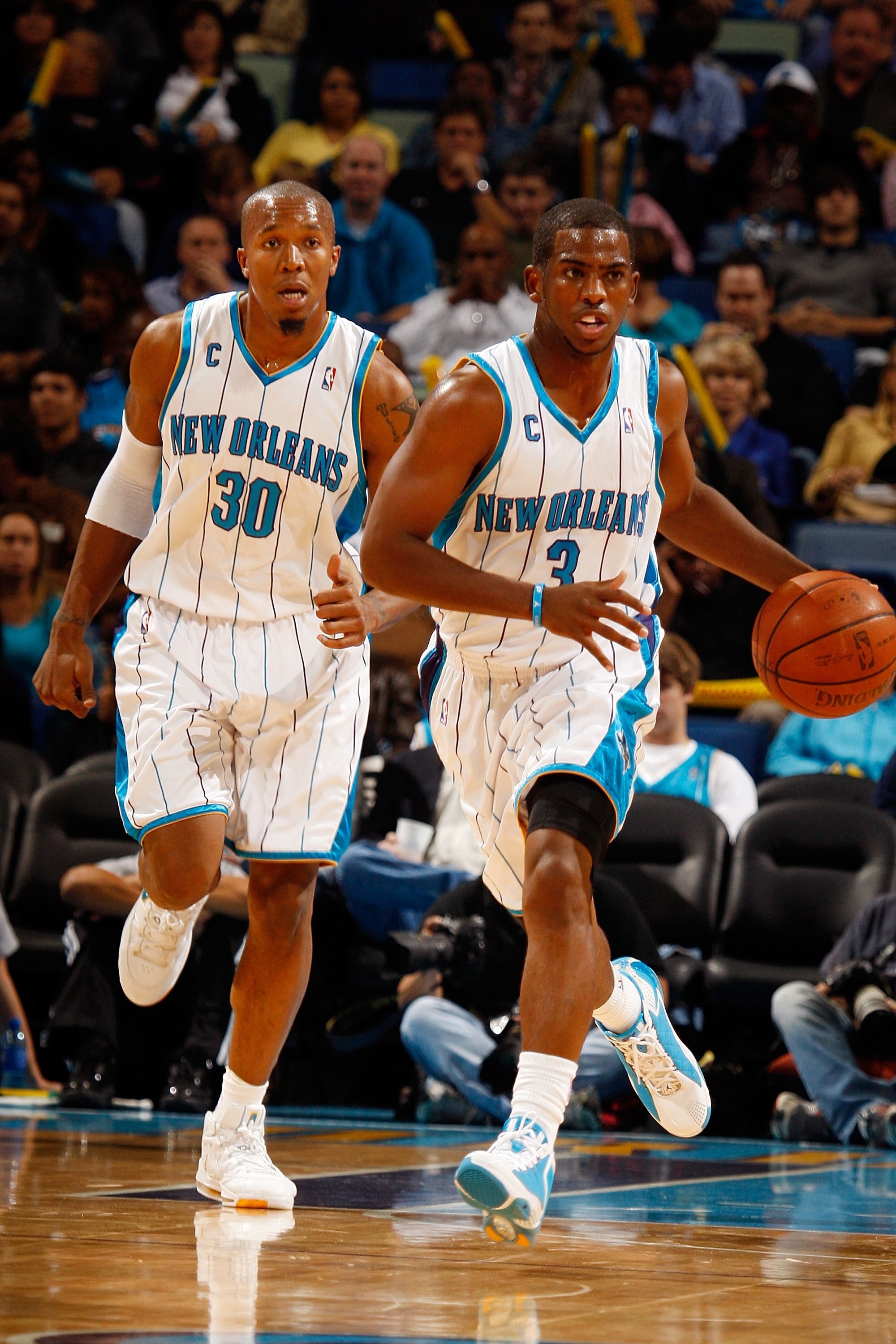 NEW ORLEANS - NOVEMBER 13:  David West #30 and Chris Paul #3 of the New Orleans Hornets is carried off the court after falling against the Portland Trail Blazers at the New Orleans Arena on November 13, 2009 in New Orleans, Louisiana.  NOTE TO USER: User