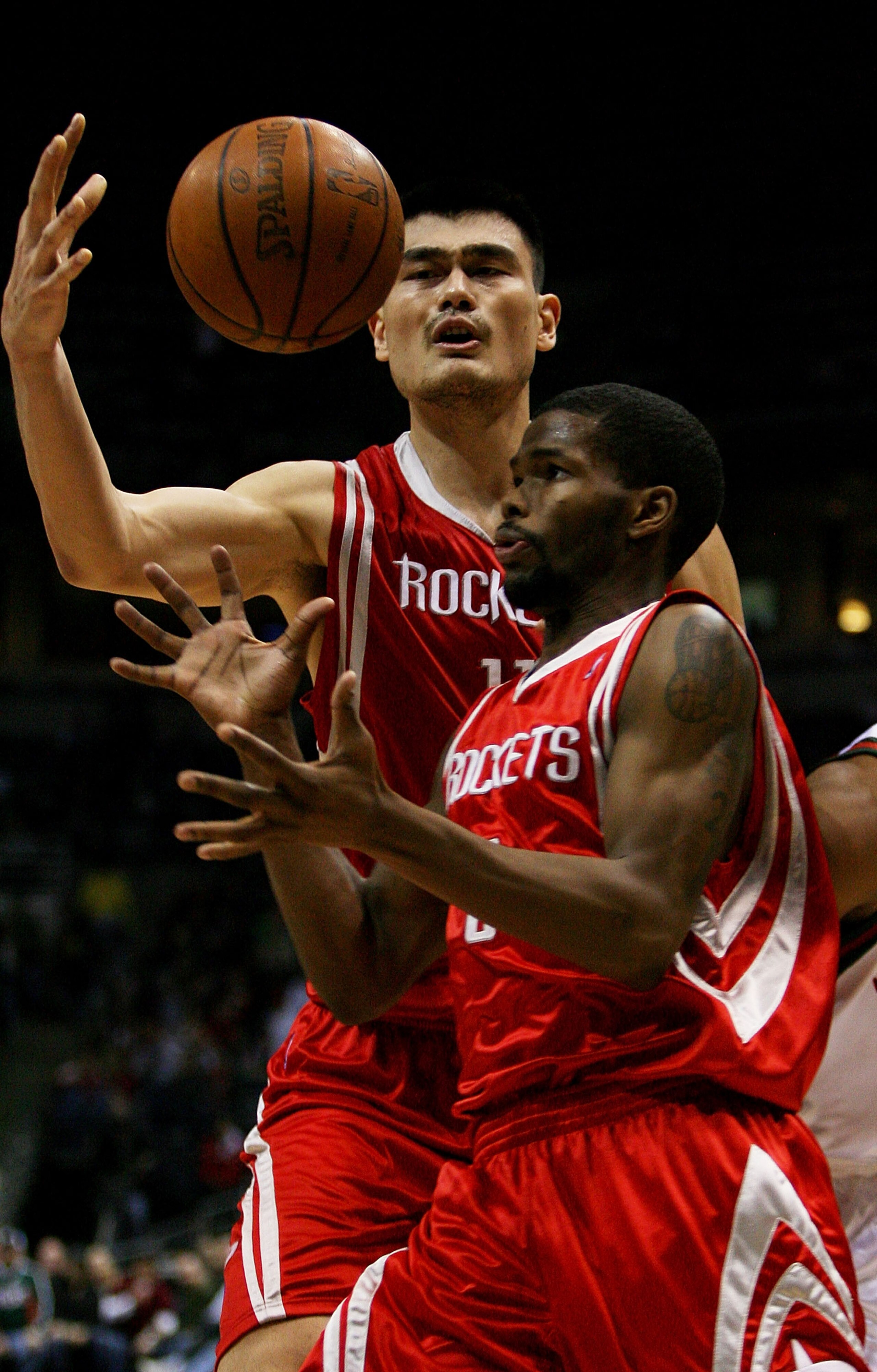 MILWAUKEE - FEBRUARY 09:  Yao Ming #11 and Aaron Brooks #0 of the Houston Rockets try to control the ball during a game against the Milwaukee Bucks on February 9, 2009 at the Bradley Center in Milwaukee, Wisconsin. NOTE TO USER: User expressly acknowledge