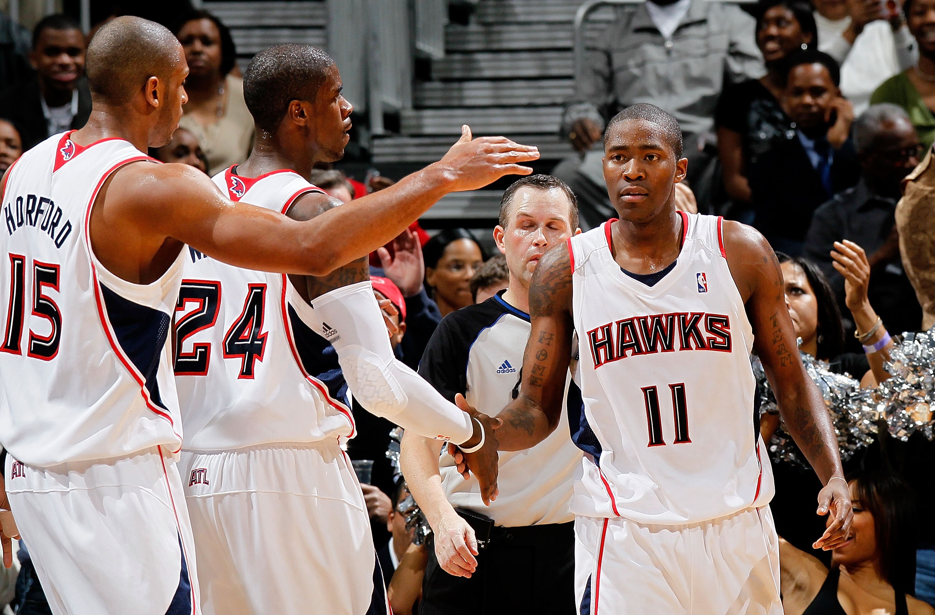 ATLANTA - JANUARY 29:  Jamal Crawford #11 of the Atlanta Hawks celebrates his basket and drawing a foul from the Boston Celtics with Al Horford #15 and Marvin Williams #24 at Philips Arena on January 29, 2010 in Atlanta, Georgia.  NOTE TO USER: User expre