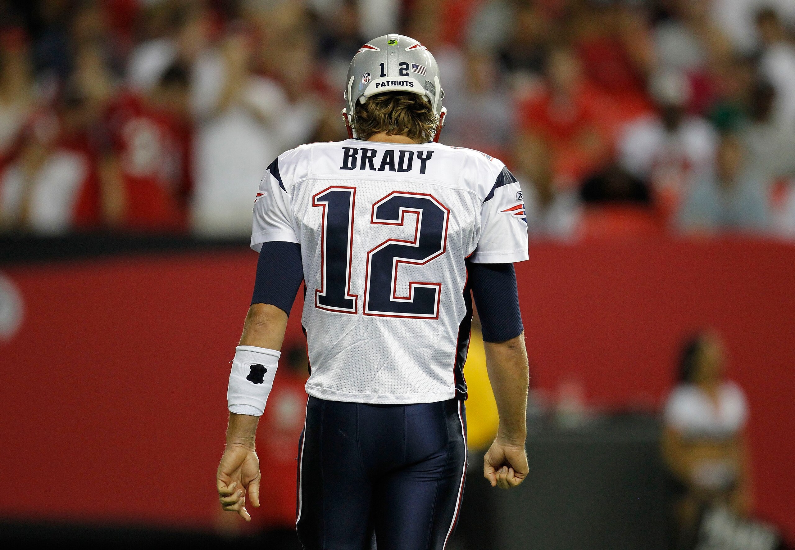 ATLANTA - AUGUST 19:  Quarterback Tom Brady #12 of the New England Patriots walks to the bench during the preseason game against the Atlanta Falcons at the Georgia Dome on August 19, 2010 in Atlanta, Georgia.  The Patriots beat the Falcons 28-10.  (Photo