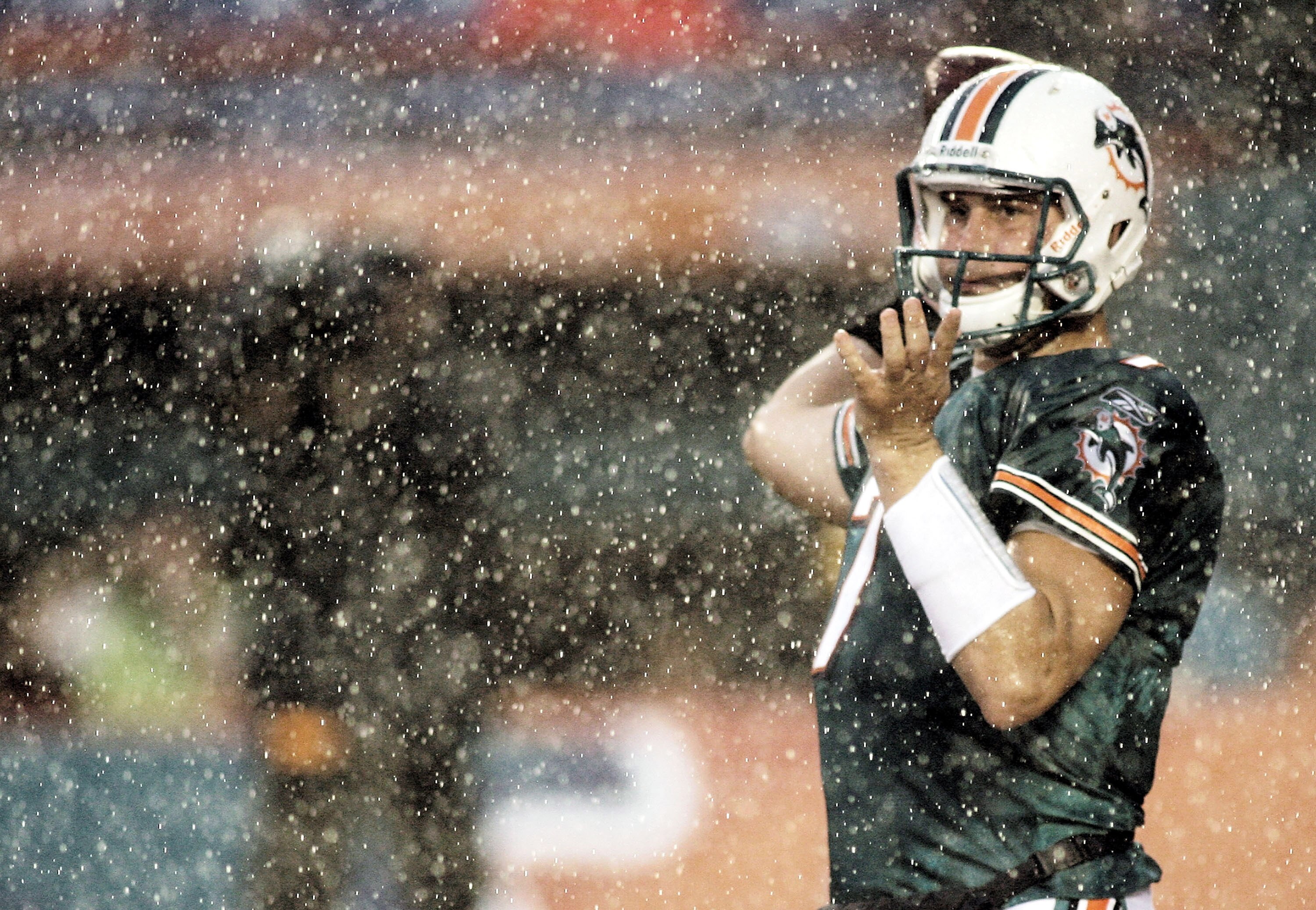 MIAMI - AUGUST 14:  Quarterback Chad Henne #7   of the Miami Dolphins passes in heavy rain against  the Tampa Bay Buccaneers during the preseason game at Sun Life Stadium on August 14, 2010 in Miami, Florida.  (Photo by Marc Serota/Getty Images)