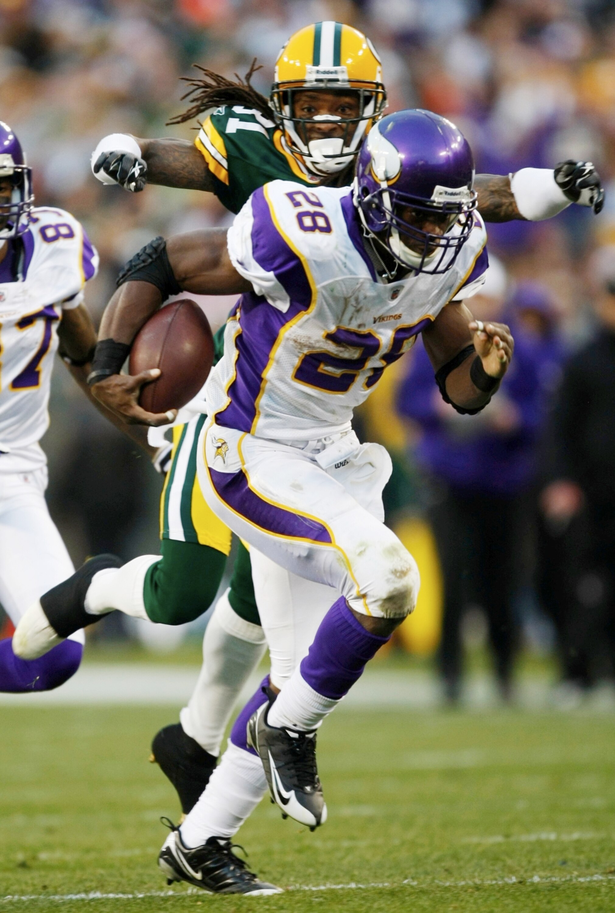 GREEN BAY, WI - NOVEMBER 01:  Al Harris #31 of the Green Bay Packers tackles Adrian Peterson #28 of the Minnesota Vikings during the third quarter of the game at Lambeau Field on November 1, 2009 in Green Bay, Wisconsin. (Photo by Scott Boehm/Getty Images