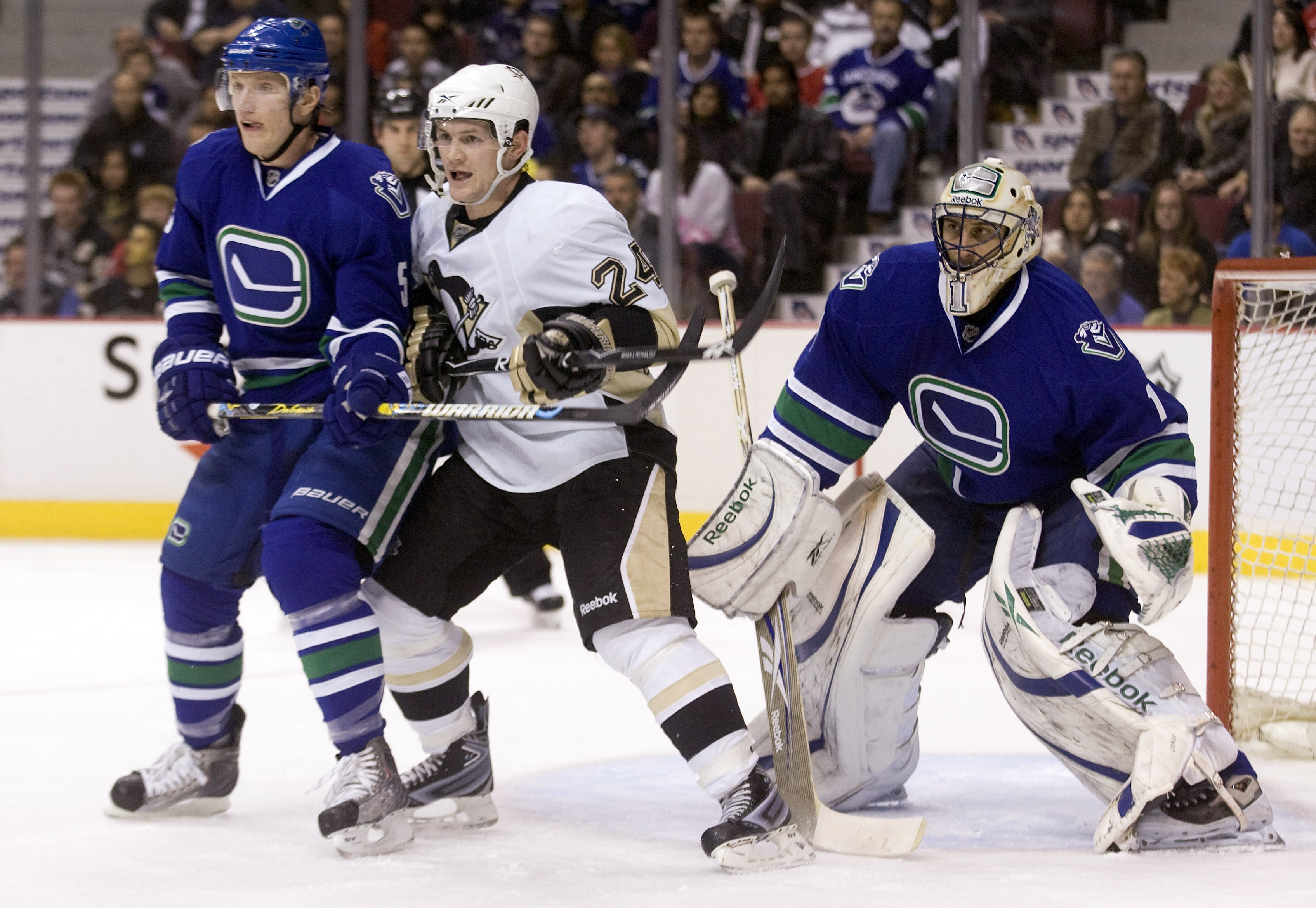 VANCOUVER, CANADA - JANUARY 16: Matt Cooke #24 of the Pittsburgh Penguins battles with Christian Ehrhoff #5 of the Vancouver Canucks while trying to scree goalie Roberto Luongo #1 during the first period of NHL action on January 16, 2010 at General Motors