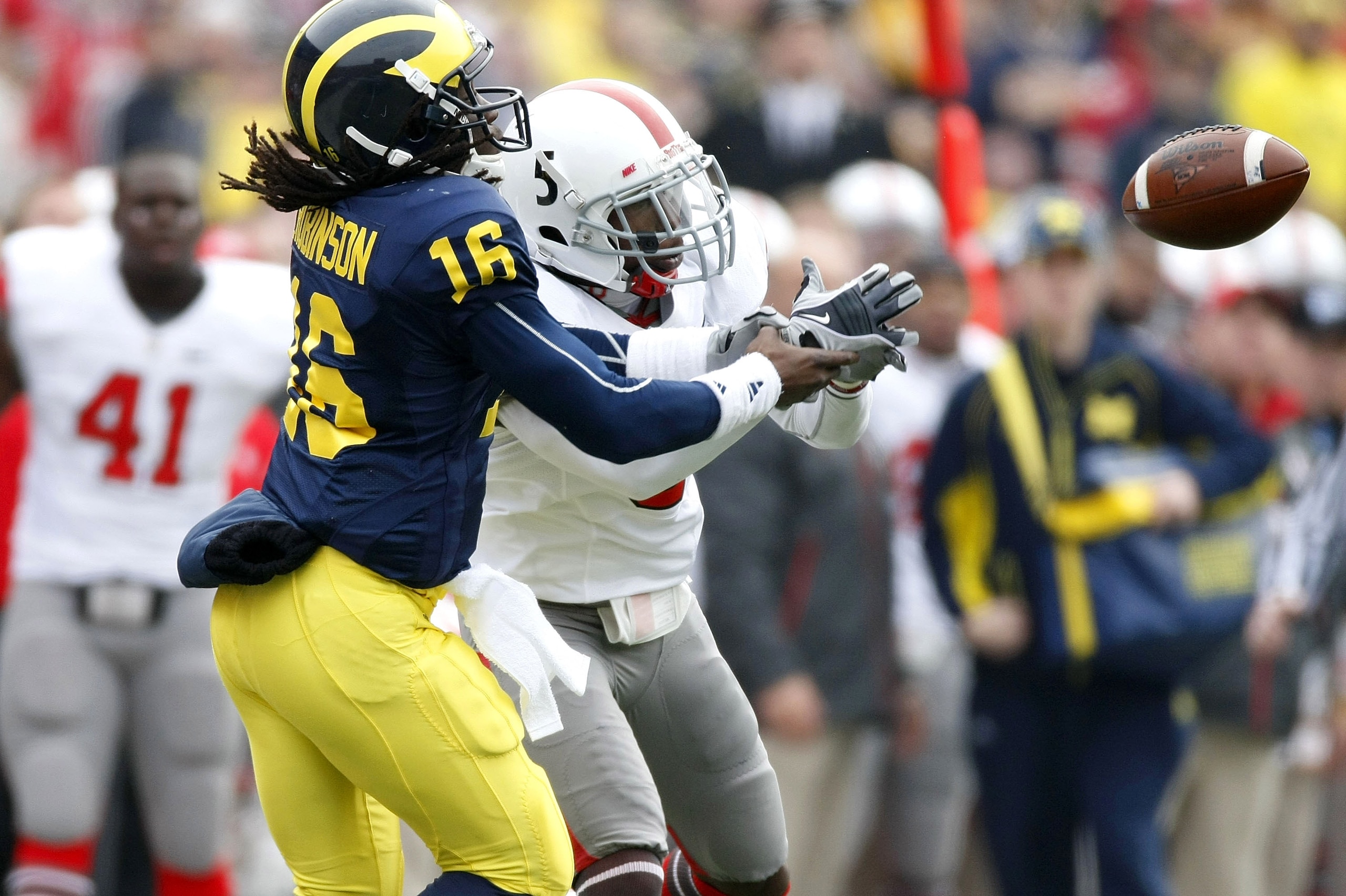 ANN ARBOR, MI - NOVEMBER 21: Denard Robinson #16 of the Michigan Wolverines tries to catch a second quarter pass behind Chimdi Chekwa #5 of the Ohio State Buckeyes on November 21, 2009 at Michigan Stadium in Ann Arbor, Michigan.  (Photo by Gregory Shamus/
