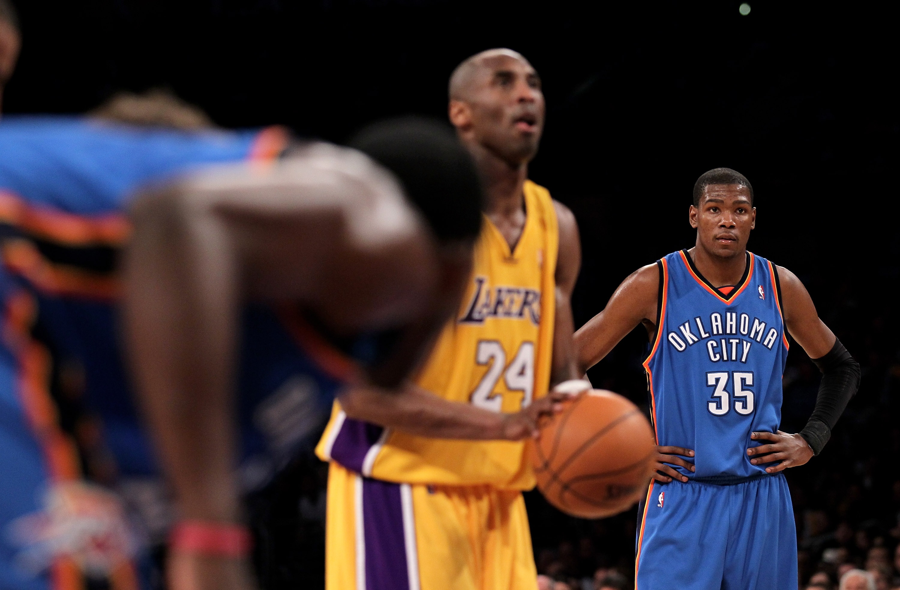 LOS ANGELES - APRIL 20:  Kevin Durant#35 of the Oklahoma City Thunder looks on as Kobe Bryant #24 of the Los Angeles Lakers shoots a foul shot during  Game Two of the Western Conference Quarterfinals of the 2010 NBA Playoffs on April 20, 2010 at Staples C